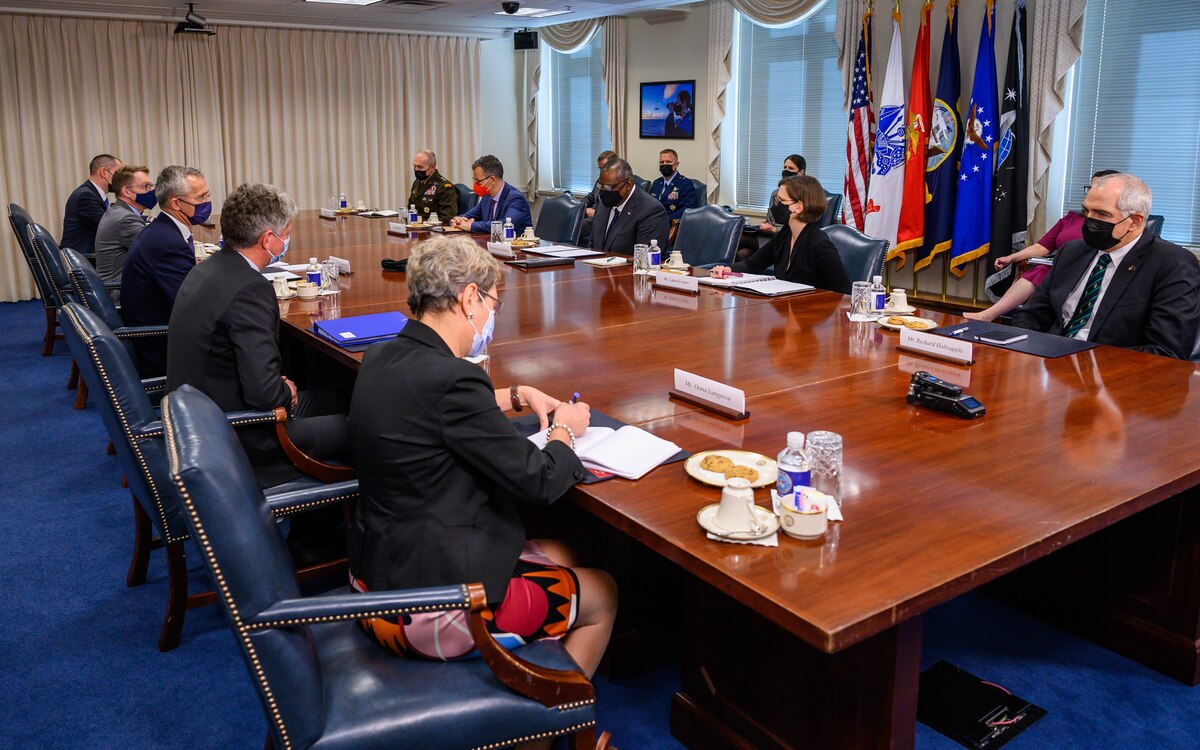 Two delegations meet in a conference room.