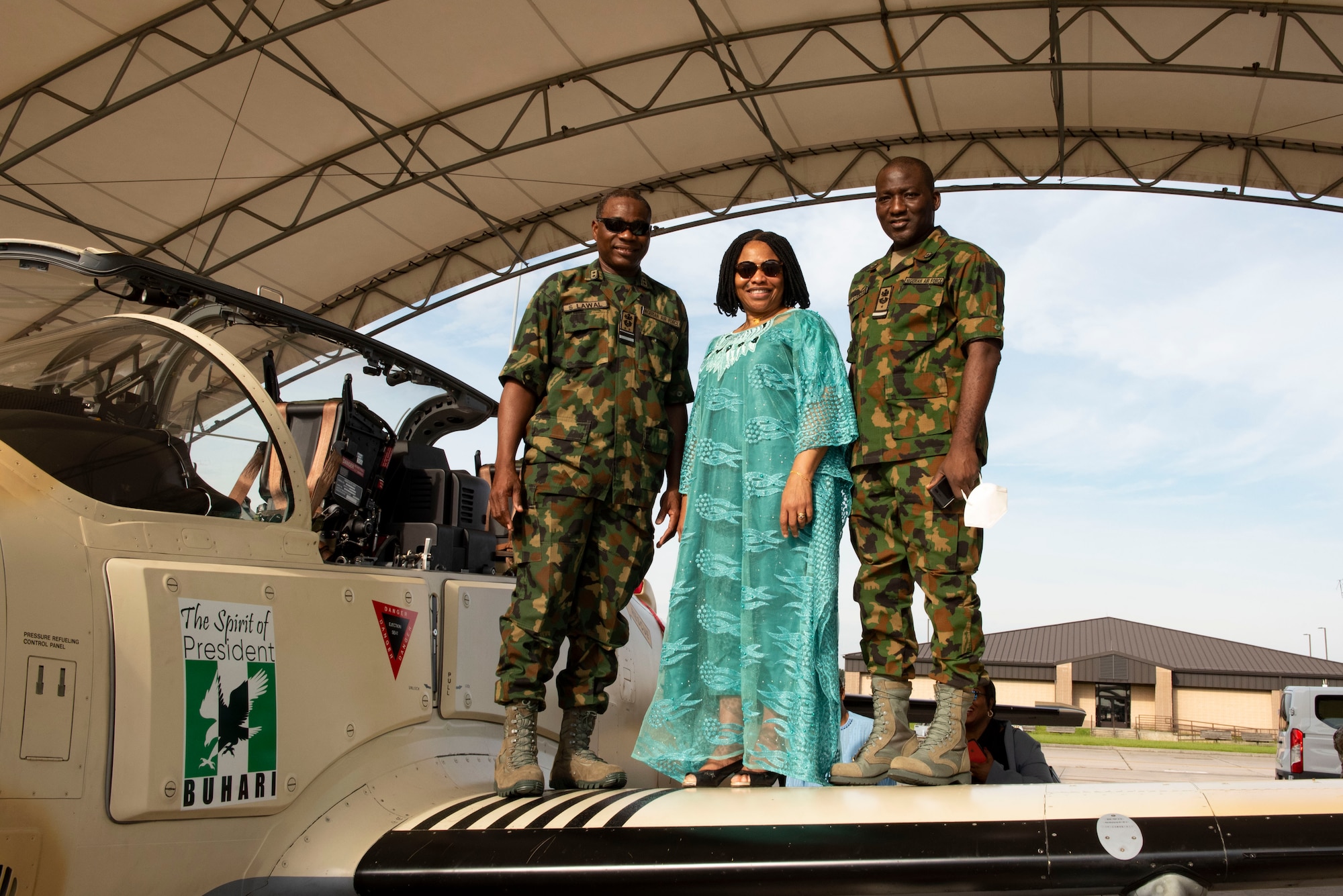 Sule Baba Lawal, Nigerian Air Vice-Marshal, right; Uzoma Elizabeth Emenike, Nigerian Ambassador, center; and Jibrin Usman, Nigerian Air Commodore, pose for a photo on the wing of an A-29 Super Tucano aircraft at Moody Air Force Base, Georgia, Sept. 14, 2021. The ambassador came to the 81st FS to meet and send off the pilots who are transporting the A-29 Super Tucano aircraft from Moody AFB to Kainji Air Base, Nigeria. (U.S. Air Force photo by Airman 1st Class Megan Estrada)