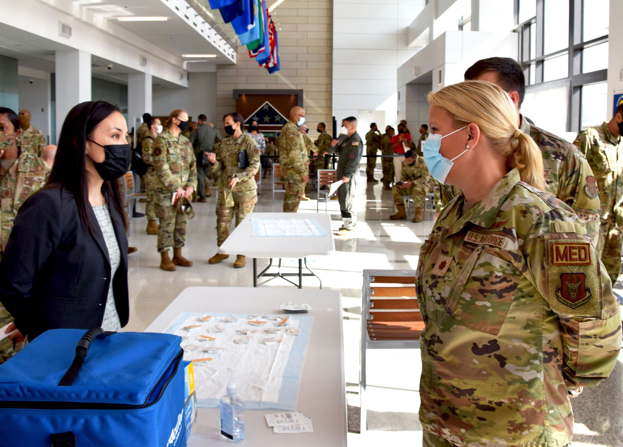 Under Secretary of the Air Force Gina Ortiz Jones speaks with Maj. Molly McCowan, 433rd Medical Squadron clinical nurse, during her visit to 433rd Airlift Wing members at Wilford Hall Ambulatory Surgical Center, Joint Base San Antonio-Lackland, Texas, to view COVID-19 vaccination efforts, Oct. 2, 2021. (U.S. Air Force photo by Tech. Sgt. Samantha Mathison)