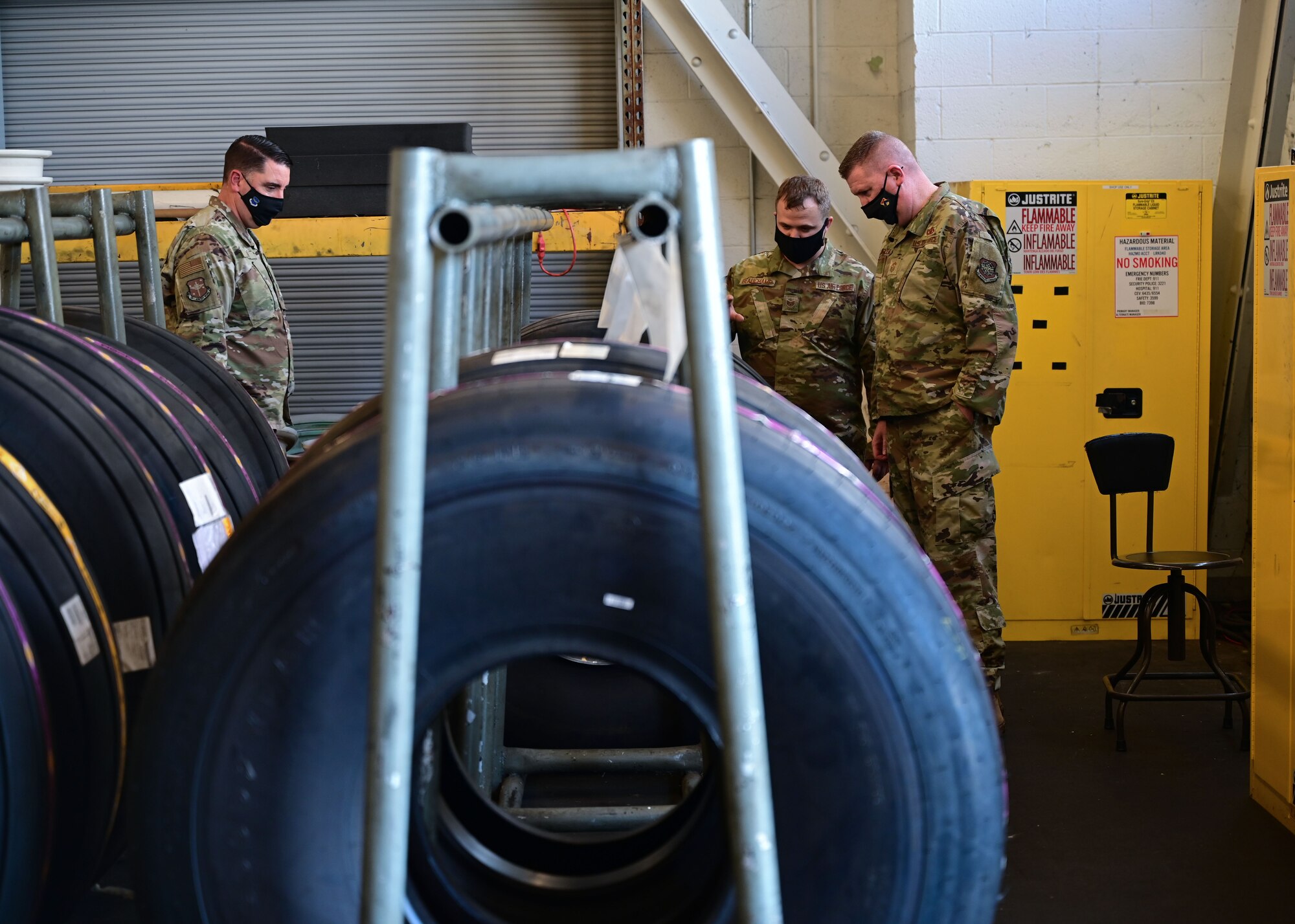 A group of people examine a C-130J tire