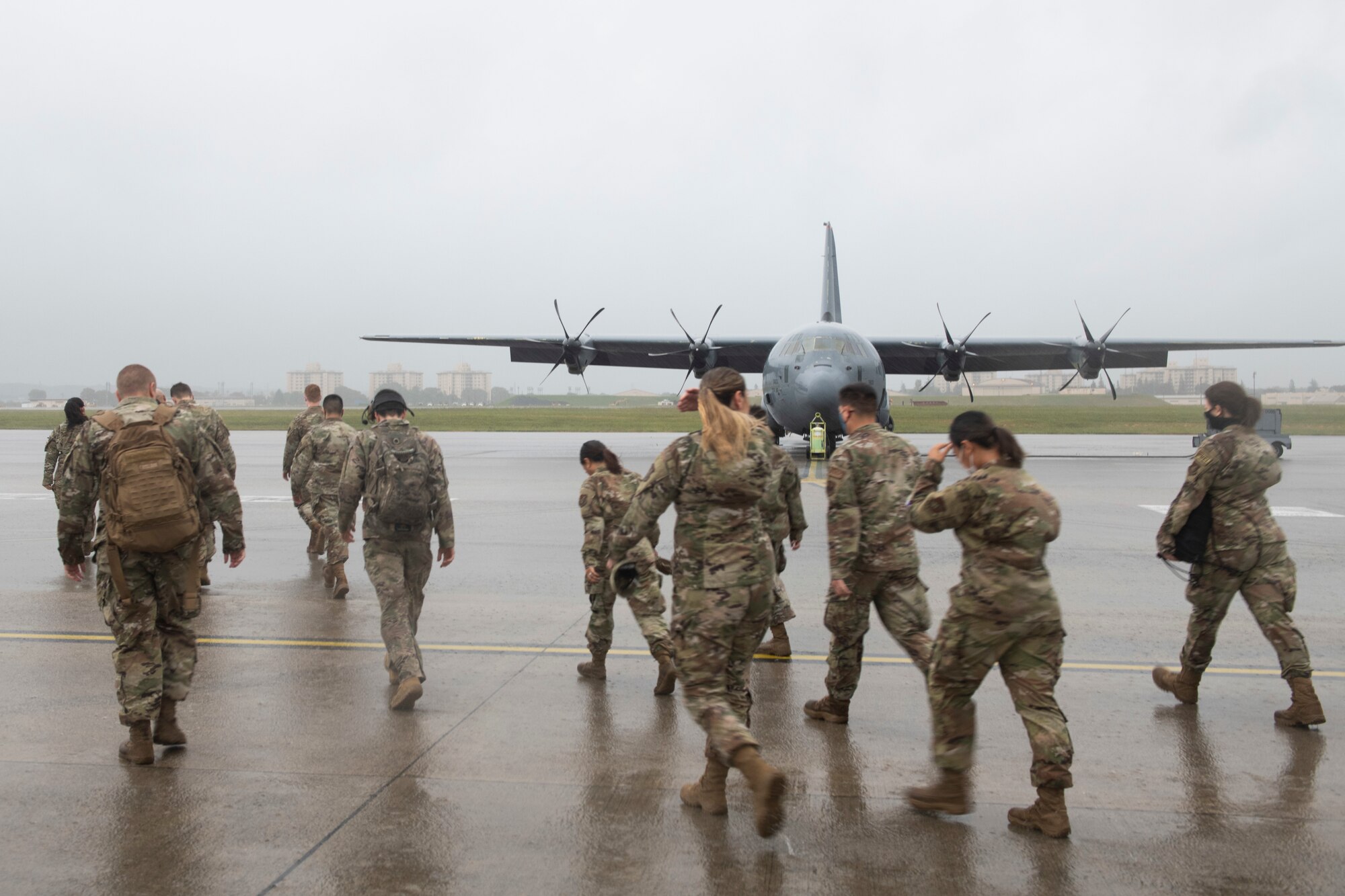 Aircrew from the 36th Airlift Squadron escort Yokota Airmen out to multiple C-130J Super Hercules at Yokota Air Base, Japan, Oct. 1, 2021. The 36th AS provided incentive flights to annual and quarterly award winners, which allowed many who do not get see the mission they support first-hand to experience agile airlift with their own eyes. (U.S. Air Force photo by Staff Sgt. Joshua Edwards)