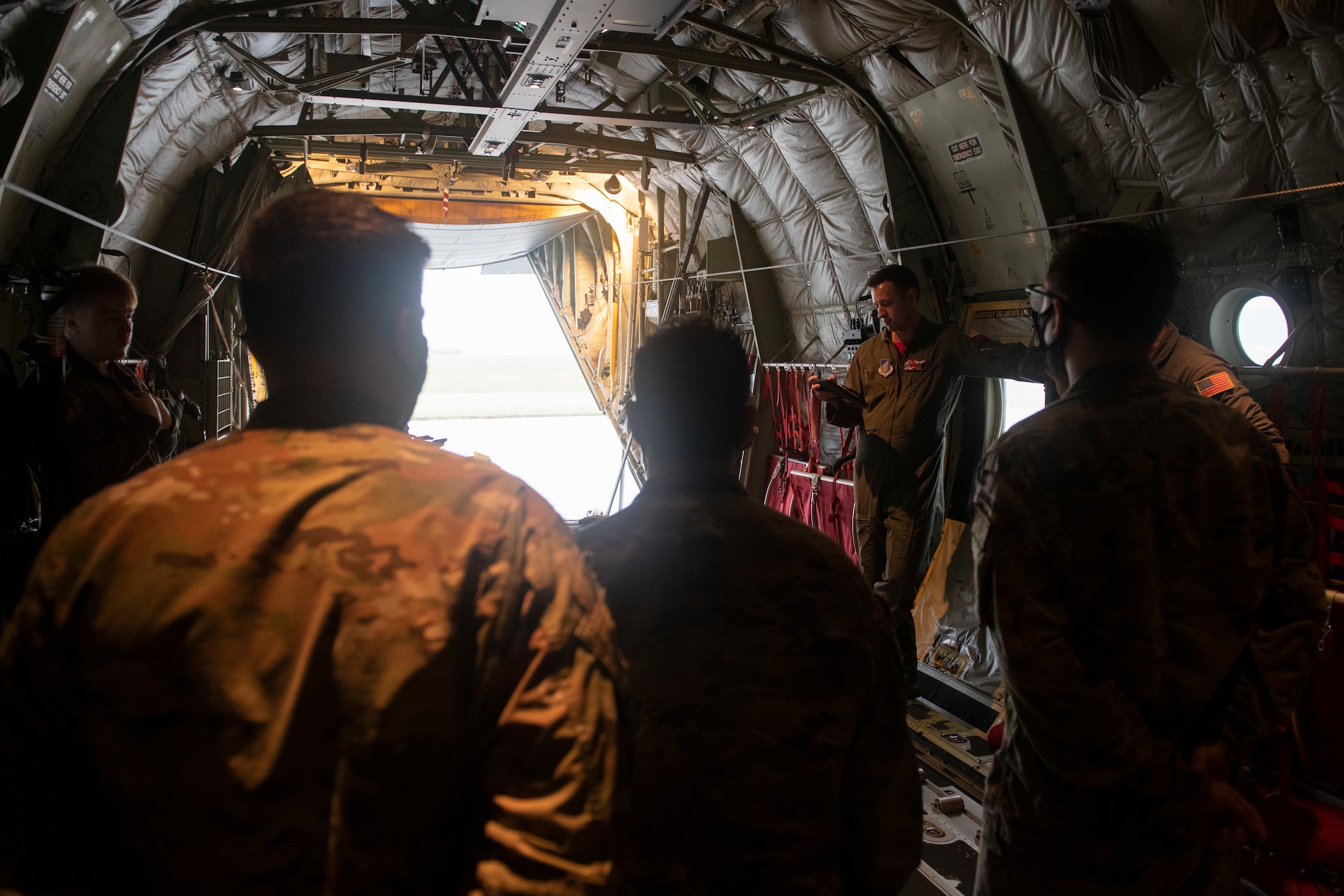 Capt. Garrett Mazachek, 36th Airlift Squadron pilot, provides a pre-flight brief prior to an incentive flight on a C-130J Super Hercules at Yokota Air Base, Japan, Oct. 1, 2021. The brief provided insight to the crew and passengers about the type of flight they would perform and the weather conditions they could expect. (U.S. Air Force photo by Staff Sgt. Joshua Edwards)