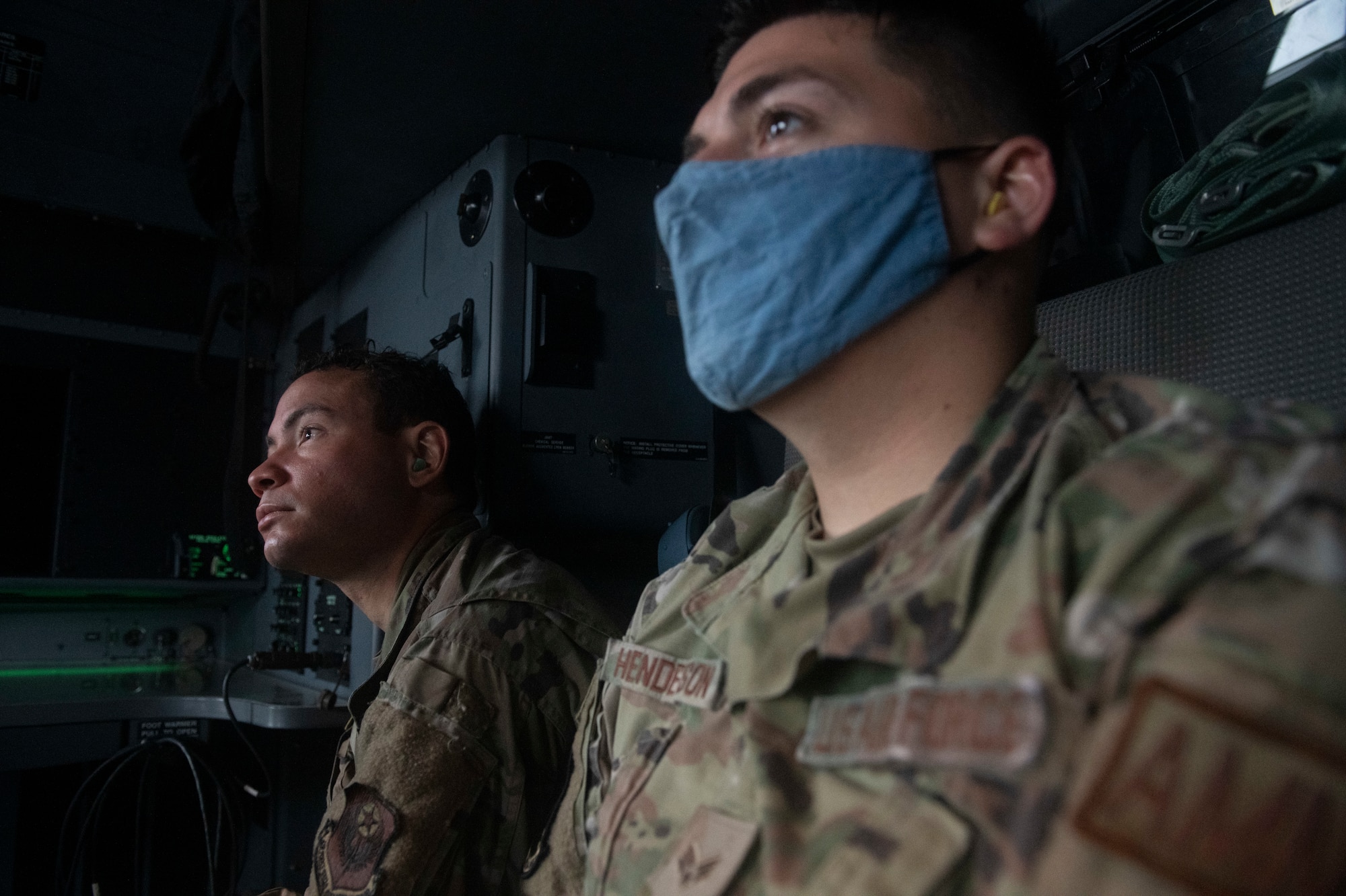 Staff Sgt. Kyle Glasford, 753rd Special Operations Aircraft Maintenance Squadron CV-22 Osprey avionics specialist, left, and Senior Airman Michael Henderson, 753rd SOAMXS munitions systems inspector, wait and watch prior to takeoff during an incentive flight on a C-130J Super Hercules at Yokota Air Base, Japan, Oct. 1, 2021. Glasford and Henderson work on CV-22s and the incentive flight gave them a chance to learn more about a different type of aircraft. (U.S. Air Force photo by Staff Sgt. Joshua Edwards)