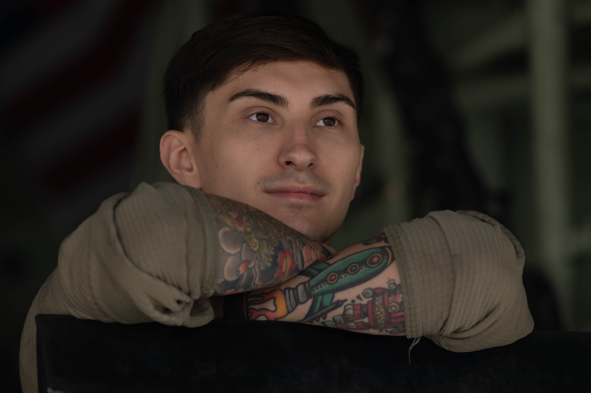 An Airman rests on a ground loading ramp.