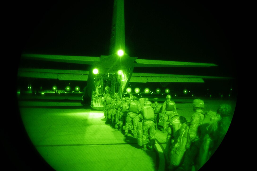 Soldiers line up in front of a C-130J Super Hercules aircraft.
