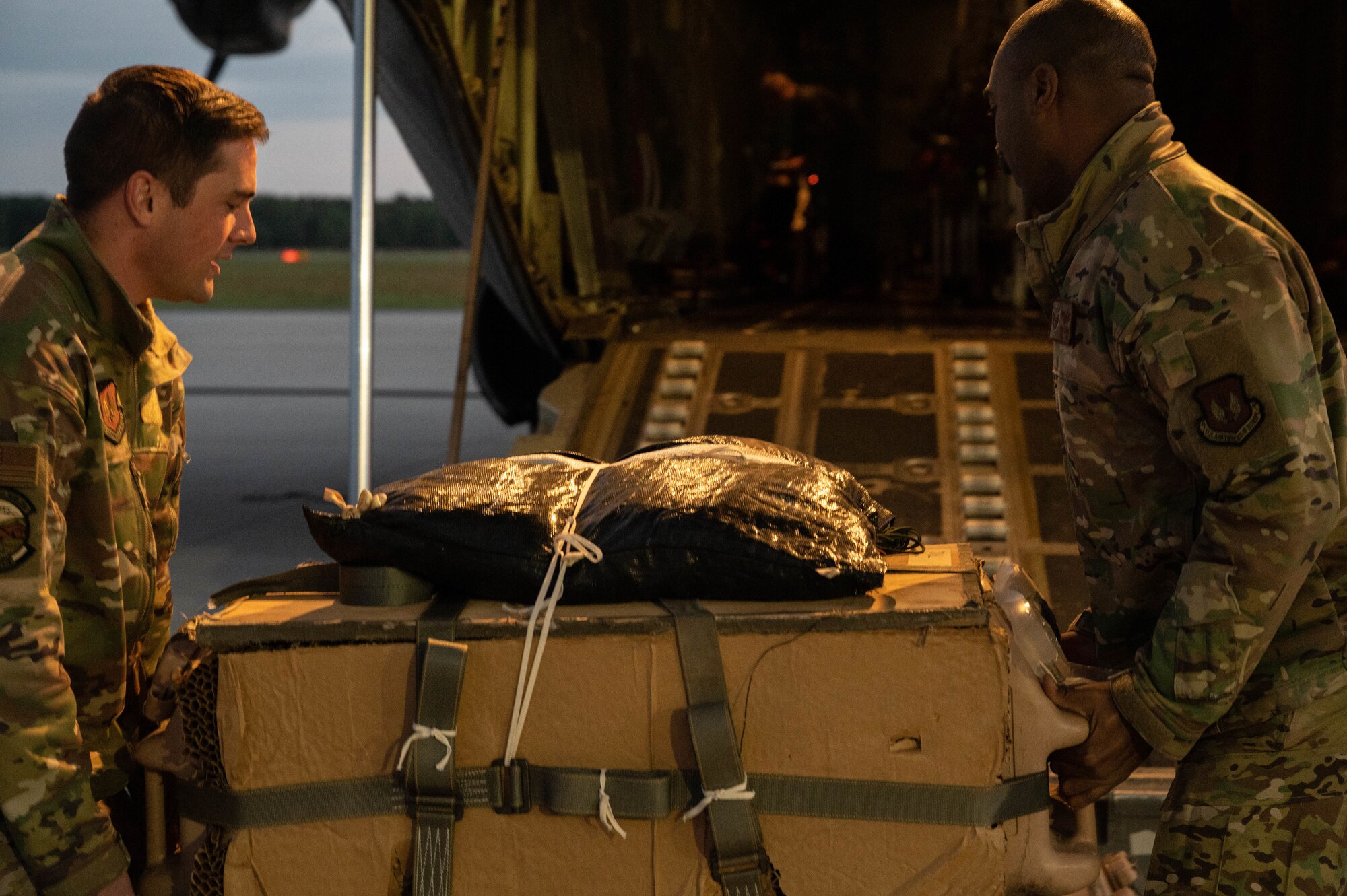Airmen pick up a low cost low altitude airdrop.