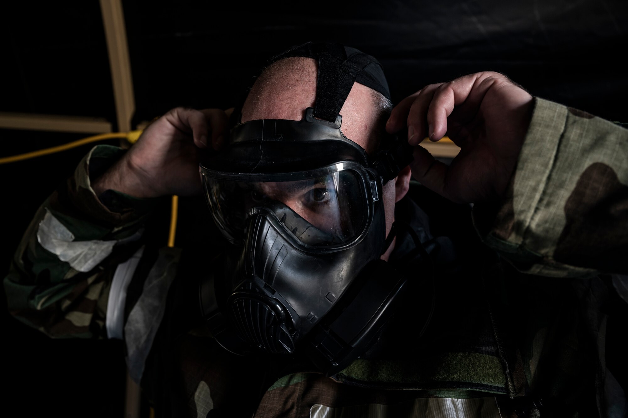 Master Sgt. Christopher Spratley, 32nd Aerial Port Squadron ramp operations supervisor, dons his gas mask while moving into Mission-Oriented Protective Postures (MOPP) during an exercise at the Pittsburgh International Airport Air Reserve Station, Pennsylvania, Sept. 9, 2021.
