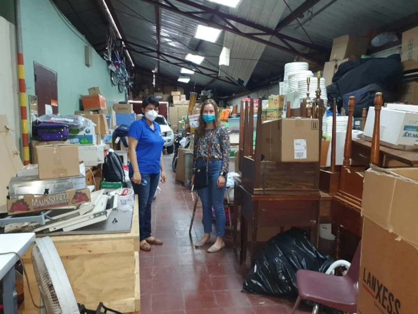 Two employees stand in the Wisconsin/Nicaragua Partners of the Americas Inc. headquarters and warehouse where all donated items are offloaded and organized before being redistributed across Nicaragua. The Wisconsin National Guard helps support aid programs like the Wisconsin/Nicaragua Partners as part of its State Partnership Program with Nicaragua.