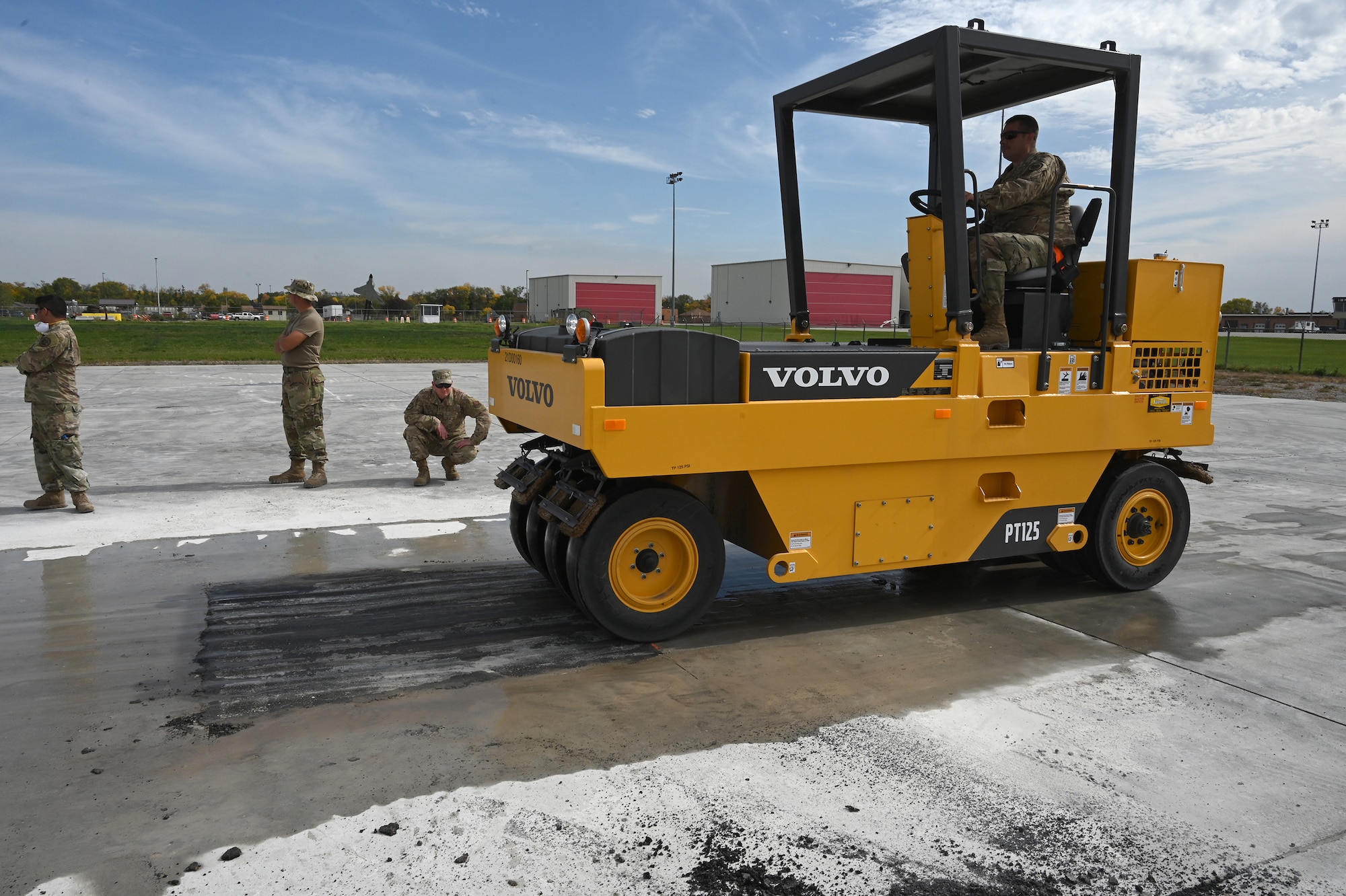 A military member operates a wheeled asphalt compactor as he levels an asphalt patch on a concrete training runway at the North Dakota Air National Guard Regional Training Site, Fargo, N.D., Sept. 29, 2021.