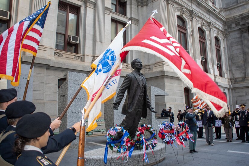 Attendees at the annual Maj. Octavius V. Catto Honor Ceremony salute during the playing of "Taps" at the Catto Monument at Philadelphia City Hall on Oct. 2, 2021.