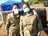 Alaska Air National Guard Staff Sgts. Sharon Queenie, left, and Judy Phommathep, assigned to the 176th Air Defense Squadron, Joint Base Elmendorf-Richardson, Alaska, during a break as public safety team members at TF Liberty Village 3, Joint Base McGuire-Dix-Lakehurst, New Jersey, Sept. 19, 2021.