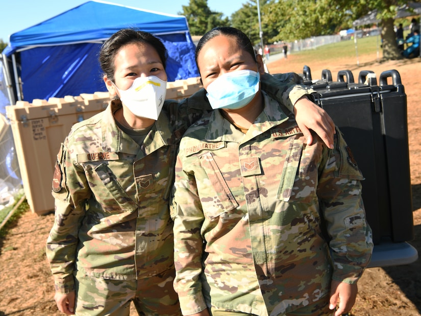 Alaska Air National Guard Staff Sgts. Sharon Queenie, left, and Judy Phommathep, assigned to the 176th Air Defense Squadron, Joint Base Elmendorf-Richardson, Alaska, during a break as public safety team members at TF Liberty Village 3, Joint Base McGuire-Dix-Lakehurst, New Jersey, Sept. 19, 2021.