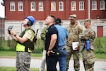A Civil Air Patrol drone pilot captures aerial views of "damaged" buildings while other team members evaluate potential structural instability during an earthquake exercise involving the Missouri Air National Guard and state and local partners in St. Louis Oct. 2, 2021.
