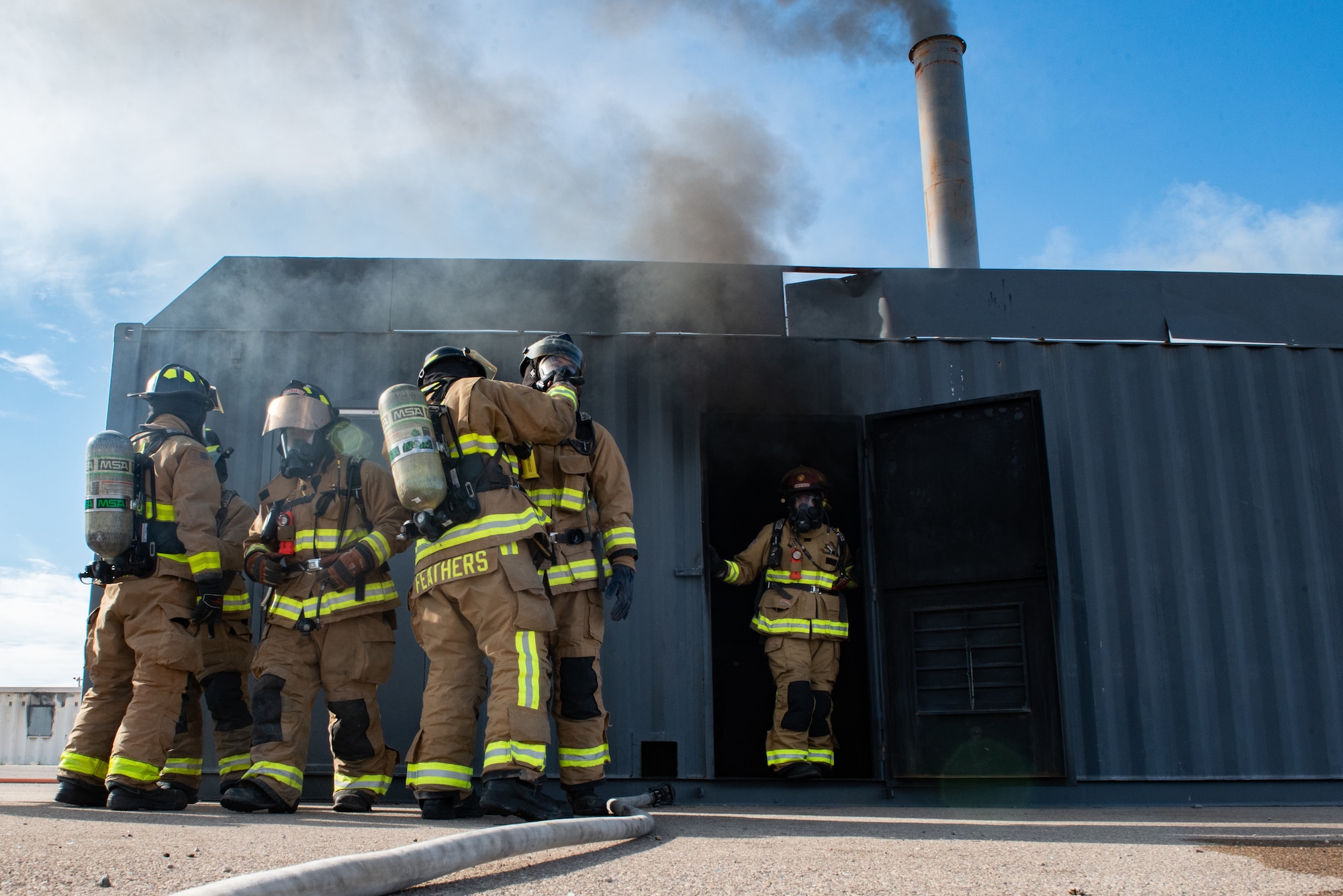 Firefighters from Task Force-Holloman train with members of the 49th Civil Engineer Squadron in a live-fire exercise Sept. 23, 2021 on Holloman Air Force Base, New Mexico. The training ensures TF-H members remain ready and improves interoperability in the event that a fire breaks out in Aman Omid Village. The Department of Defense, through U.S. Northern Command, and in support of the Department of State and Department of Homeland Security, is providing transportation, temporary housing, medical screening, and general support for at least 50,000 Afghan evacuees at suitable facilities, in permanent or temporary structures, as quickly as possible. This initiative provides Afghan evacuees essential support at secure locations outside Afghanistan. (U.S. Air Force photo by Staff Sgt. Kenneth Boyton)