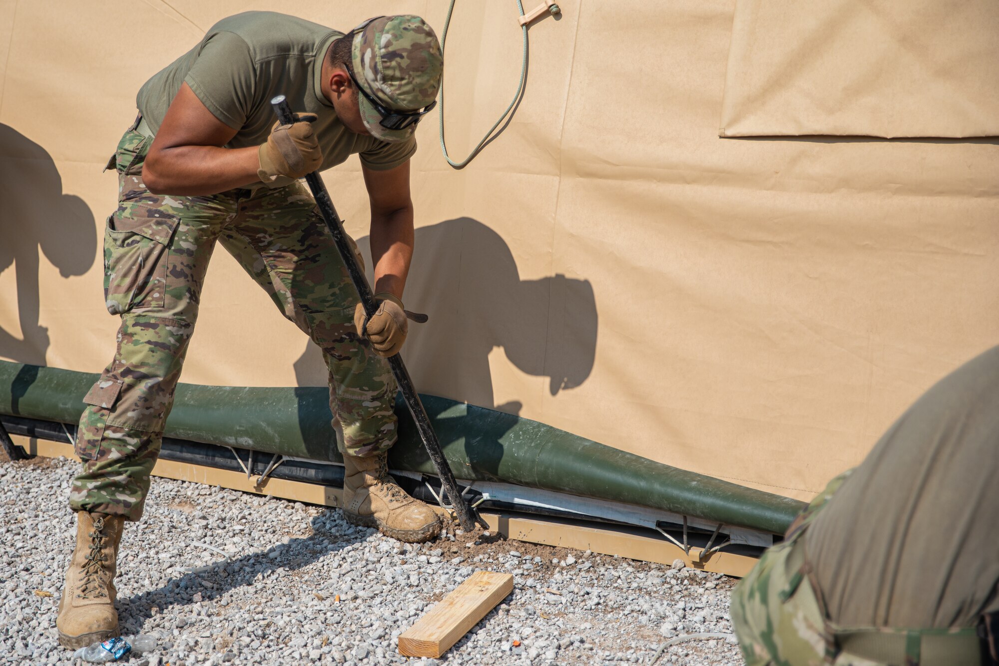 Airmen attached to Task Force-Holloman move a prayer tent and its accessories to a new location within Aman Omid Village on Holloman Air Force Base, New Mexico, Sept. 27, 2021. The Department of Defense, through U.S. Northern Command, and in support of the Department of State and Department of Homeland Security, is providing transportation, temporary housing, medical screening, and general support for at least 50,000 Afghan evacuees at suitable facilities, in permanent or temporary structures, as quickly as possible. This initiative provides Afghan evacuees essential support at secure locations outside Afghanistan. (U.S. Army photo by Pfc. Anthony Sanchez)