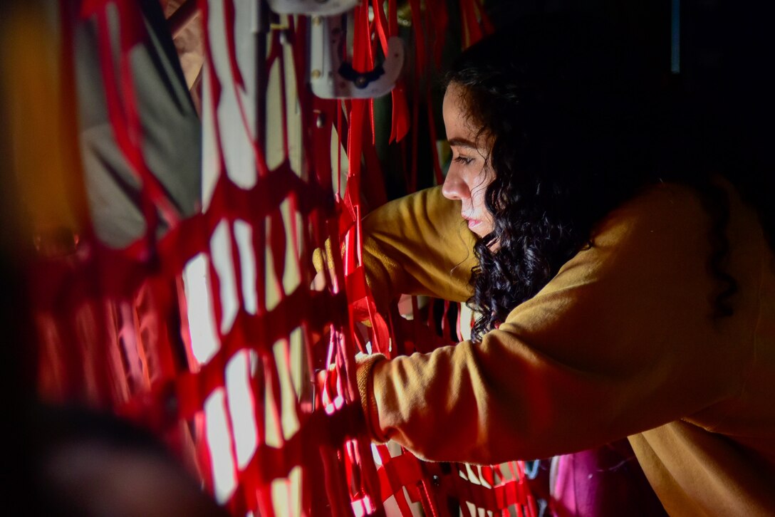 A person looks out the window of a C-130J