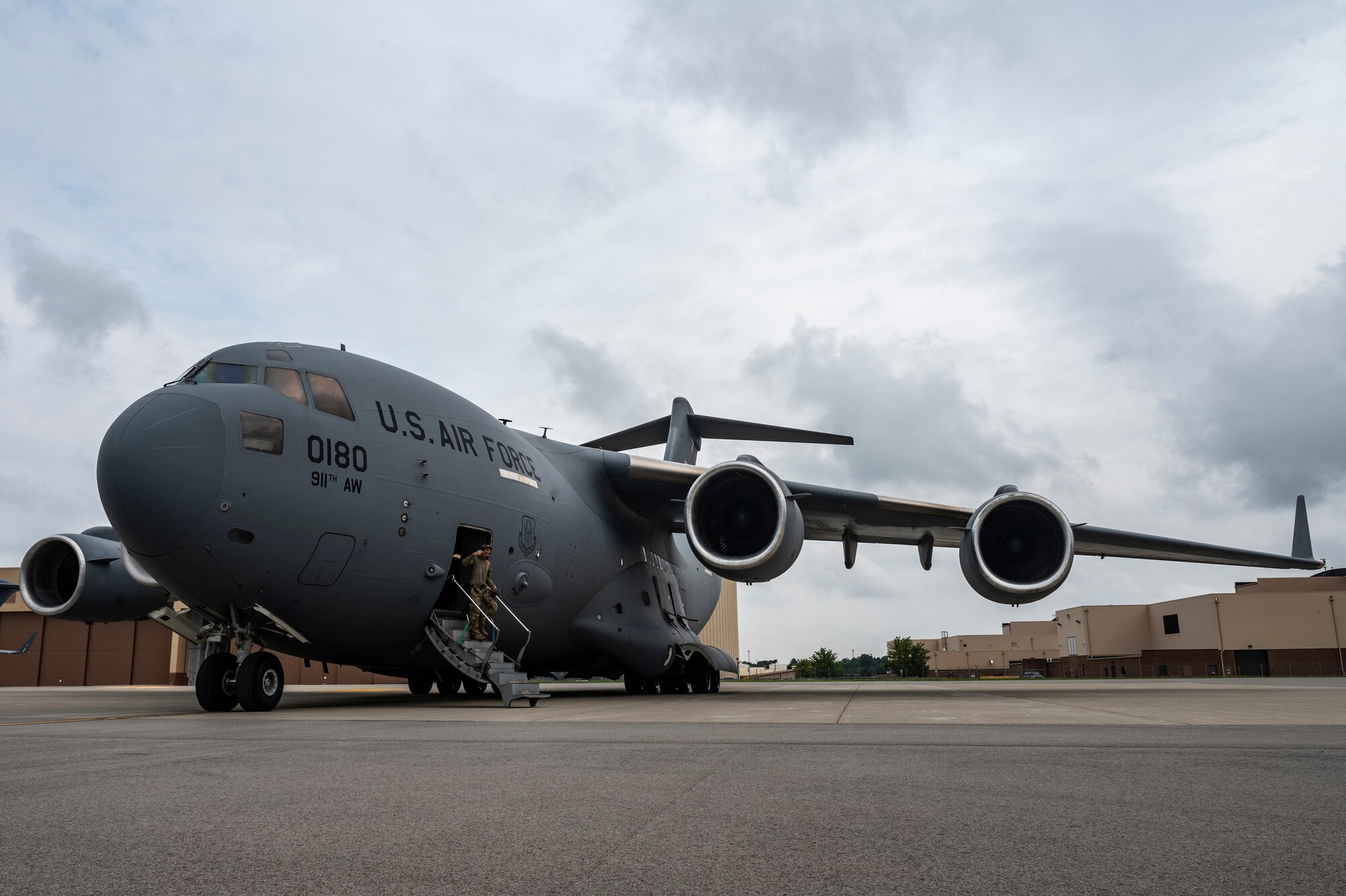 An aircrew member assigned to the 758th Airlift Squadron steps out of a C-17 Globemaster III onto the flight line at the Pittsburgh International Airport Air Reserve Station, Pennsylvania, Aug. 31, 2021.
