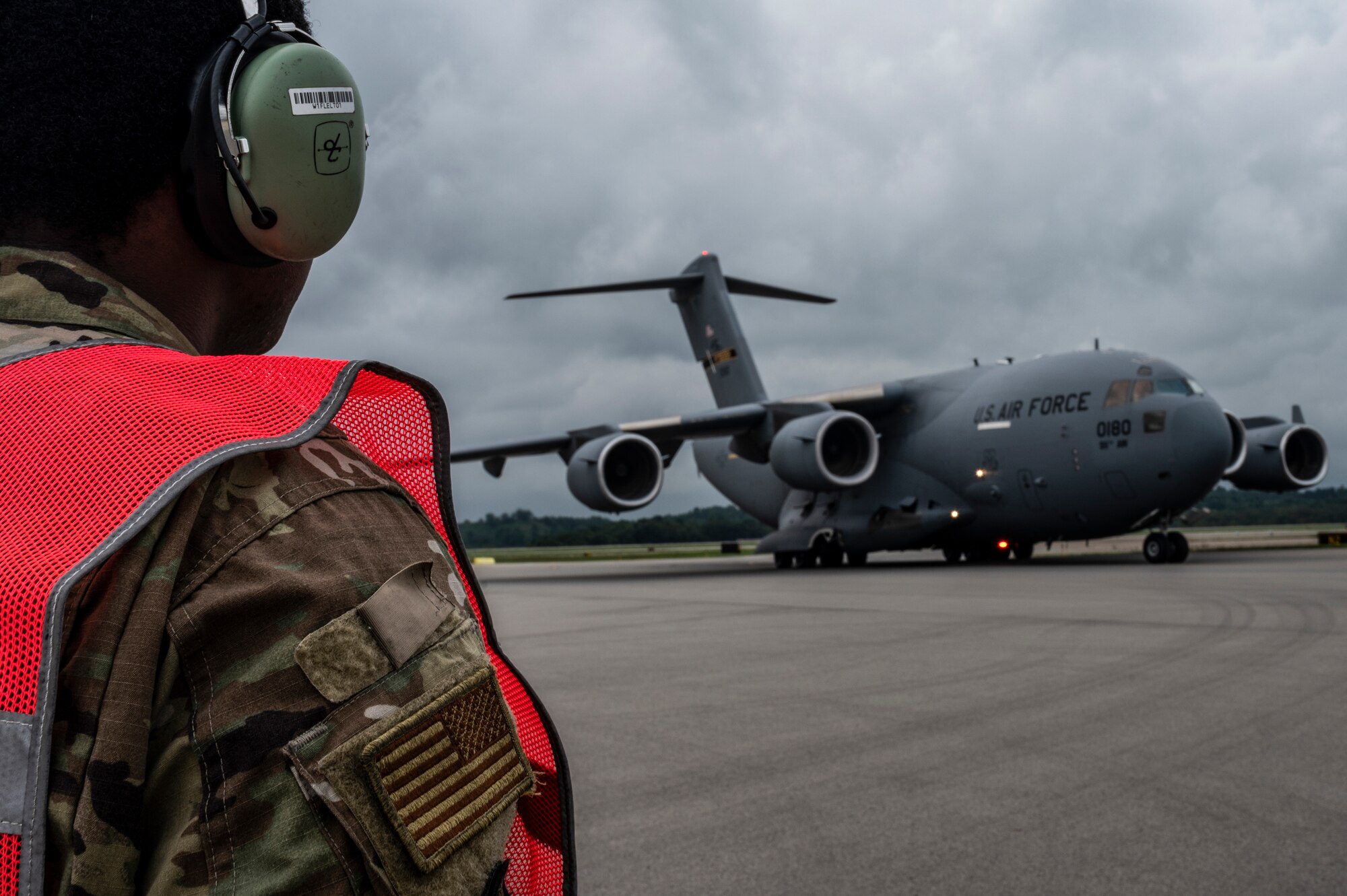 Senior Airman Elijah Turner, 911th Aircraft Maintenance Squadron crew chief, watches as a C-17 Globemaster III taxis onto the flight line at the Pittsburgh International Airport Air Reserve Station, Pennsylvania, Aug. 31, 2021.