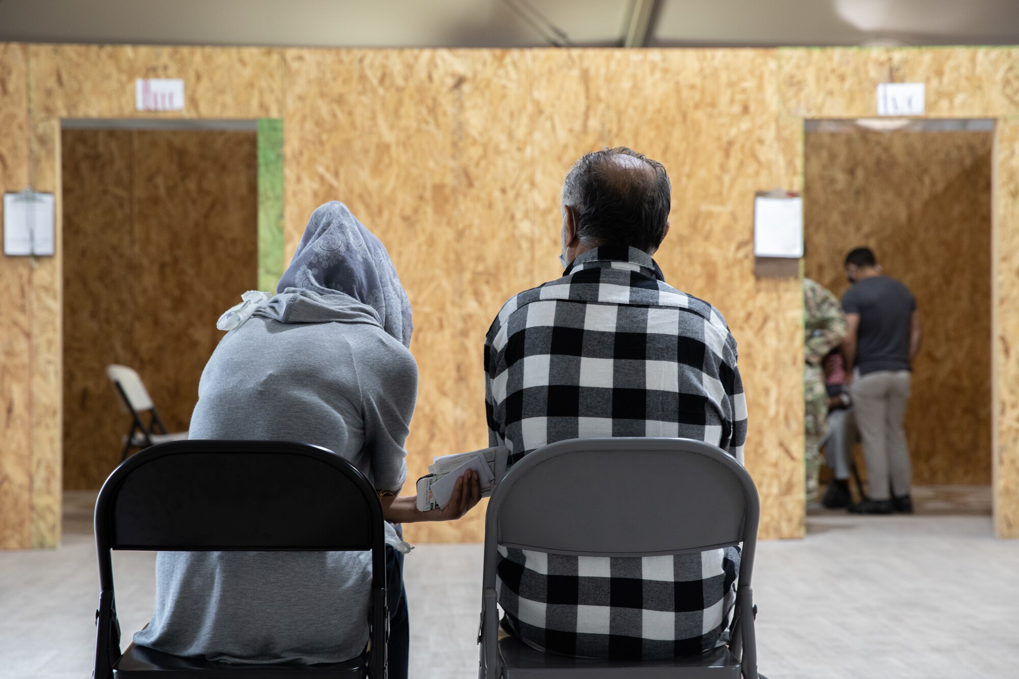 Afghan evacuees wait for triage at Aman Omid Village on Holloman Air Force Base, New Mexico, Sept. 28, 2021. The Department of Defense, through the U.S. Northern Command, and in support of the Department of State and Department of Homeland Security, is providing transportation, temporary housing, medical screening, and general support for at least 50,000 Afghan evacuees at suitable facilities, in permanent or temporary structures, as quickly as possible. This initiative provides Afghan evacuees essential support at secure locations outside Afghanistan. (U.S. Army photo by Spc. Nicholas Goodman)