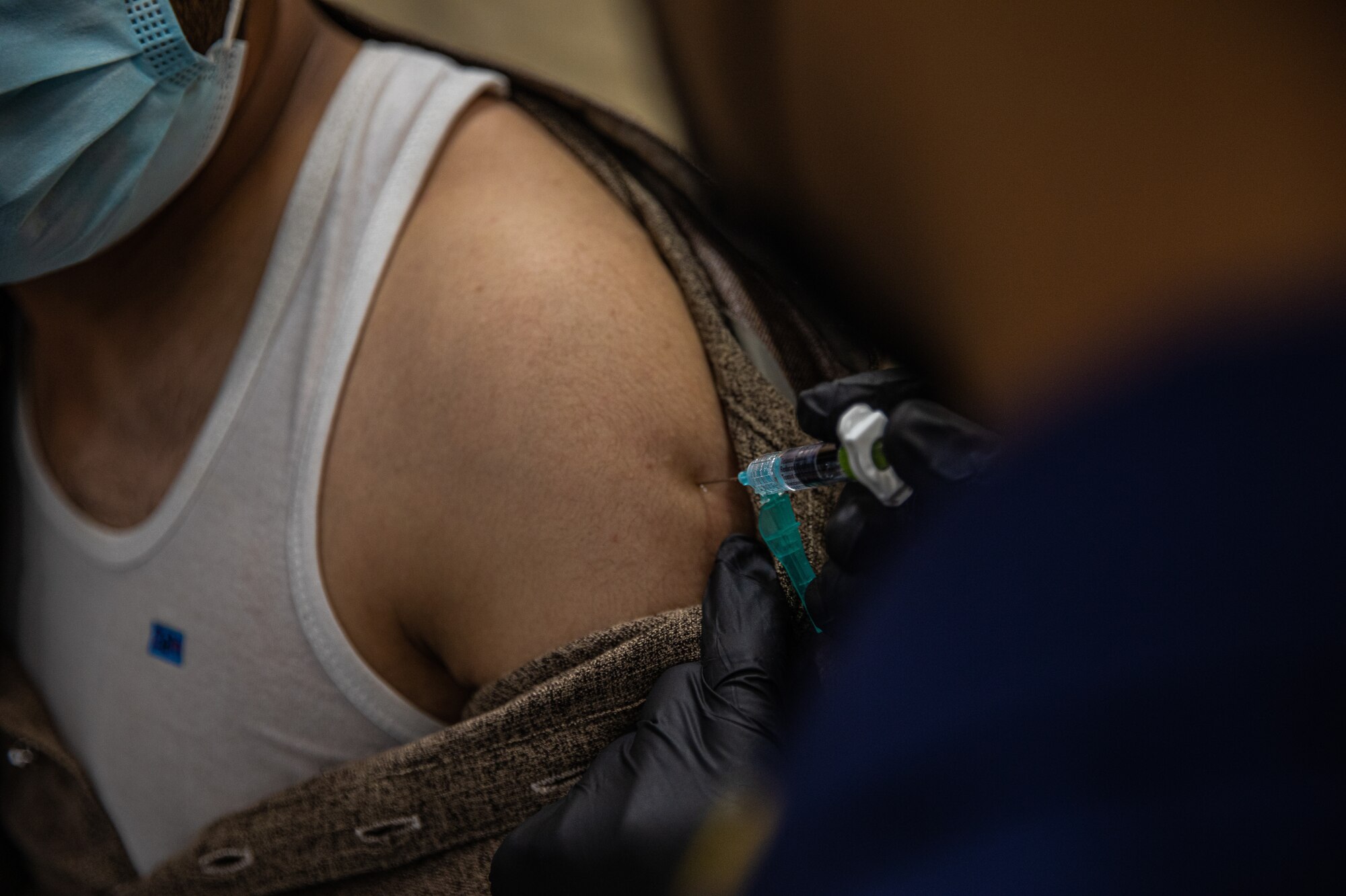 Personnel from the United States Public Health and Services Commissioned Corps, attached to Task Force-Holloman, provide Afghan evacuees with vaccinations on Holloman Air Force Base, New Mexico Sept. 26, 2021. The Department of Defense, through U.S. Northern Command, and in support of the Department of State and Department of Homeland Security, is providing transportation, temporary housing, medical screening, and general support for more than 50,000 Afghan evacuees at suitable facilities, in permanent or temporary structures, as quickly as possible. This initiative provides Afghan evacuees essential support at secure locations outside Afghanistan. (U.S. Army photo by Pfc. Anthony Sanchez)
