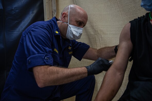 Personnel from the United States Public Health and Services Commissioned Corps, attached to Task Force-Holloman, provide Afghan evacuees with vaccinations on Holloman Air Force Base, New Mexico Sept. 26, 2021. The Department of Defense, through U.S. Northern Command, and in support of the Department of State and Department of Homeland Security, is providing transportation, temporary housing, medical screening, and general support for more than 50,000 Afghan evacuees at suitable facilities, in permanent or temporary structures, as quickly as possible. This initiative provides Afghan evacuees essential support at secure locations outside Afghanistan. (U.S. Army photo by Pfc. Anthony Sanchez)