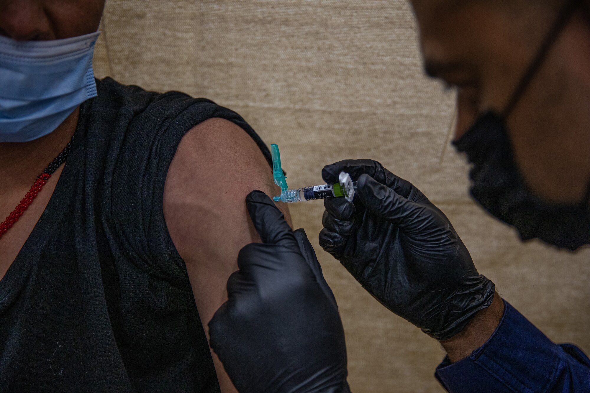 Personnel from the United States Public Health and Services Commissioned Corps, attached to Task Force-Holloman, provide Afghan evacuees with vaccinations on Holloman Air Force Base, New Mexico Sept. 26, 2021. The Department of Defense, through U.S. Northern Command, and in support of the Department of State and Department of Homeland Security, is providing transportation, temporary housing, medical screening, and general support for more than 50,000 Afghan evacuees at suitable facilities, in permanent or temporary structures, as quickly as possible. This initiative provides Afghan evacuees essential support at secure locations outside Afghanistan. (U.S. Army photo by Pfc. Anthony Sanchez)