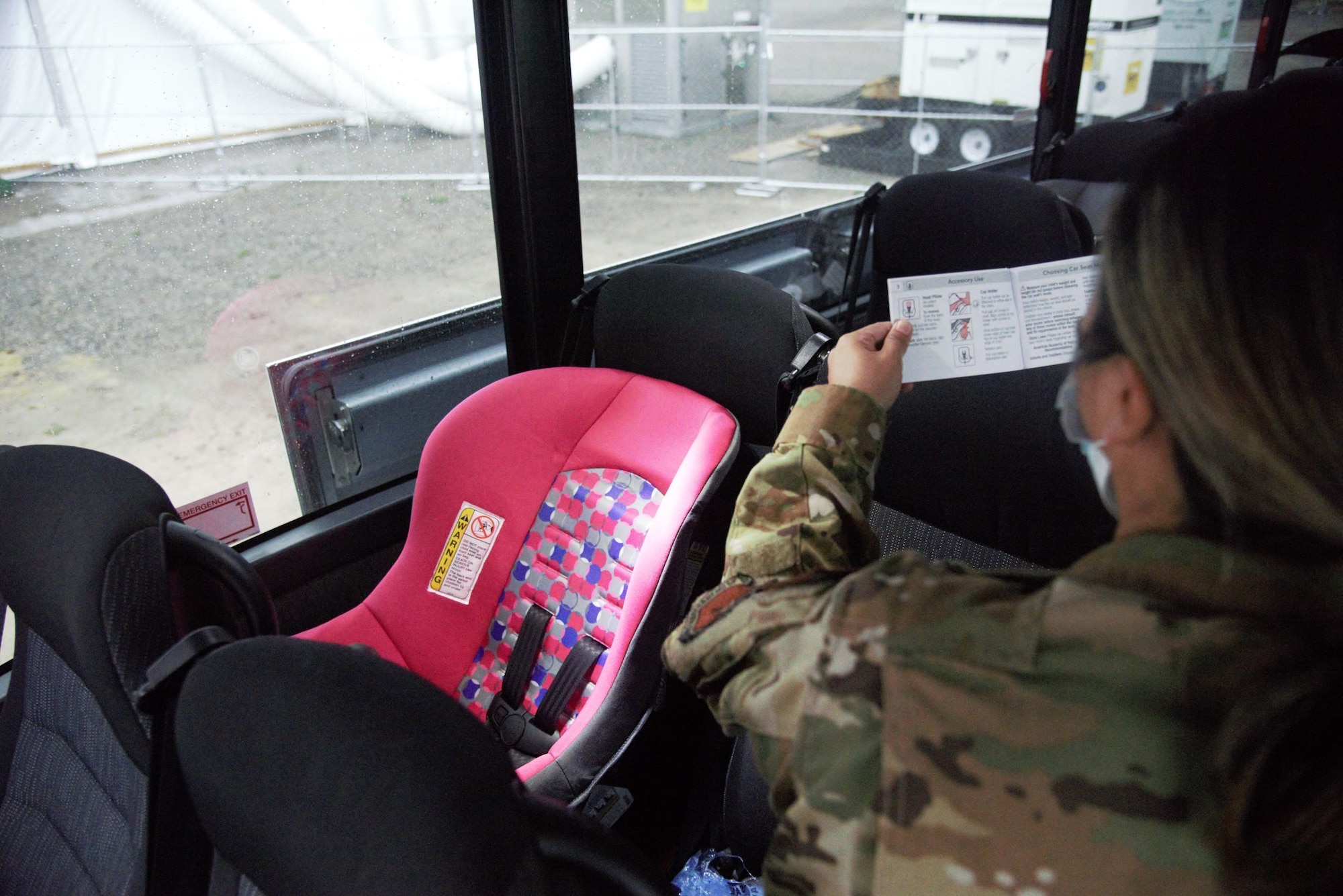 Ensuring safe travel from Aman Omid Village, military members install car seats for Afghan families with small children on Holloman Air Force Base, New Mexico, Sept 30,2021. The Department of Defense, through U.S. Northern Command, and in support of the Department of State and Department of Homeland Security, is providing transportation, temporary housing, medical screening, and general support for at least 50,000 Afghan evacuees at suitable facilities, in permanent or temporary structures, as quickly as possible. This initiative provides Afghan evacuees essential support at secure locations outside Afghanistan. (U.S. Navy photo by Mass Communications Specialist 1st Class Sarah Rolin)