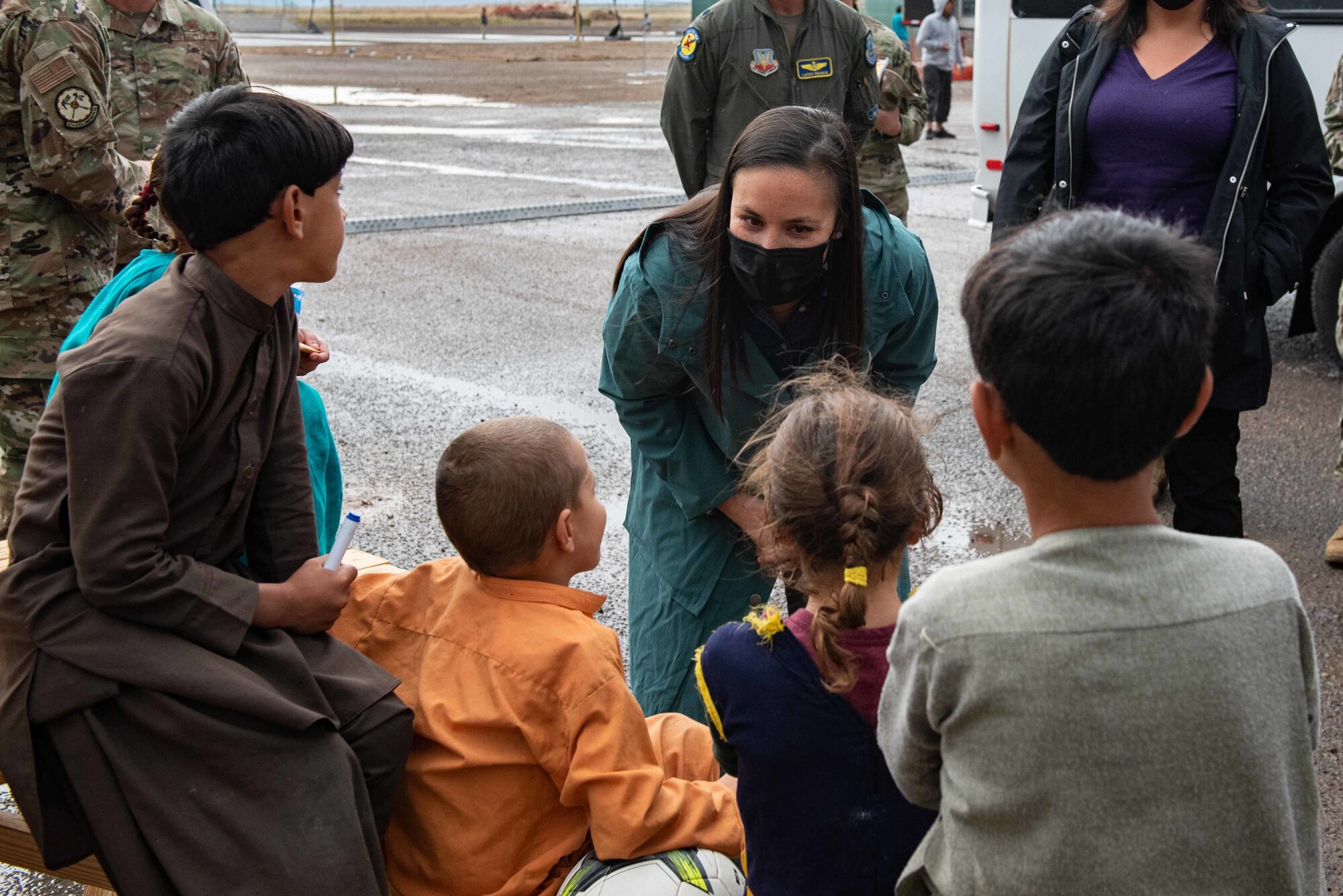 The Honorable Gina Ortiz Jones, undersecretary of the Air Force, speaks with Afghan evacuee children during her tour of Task Force-Holloman on Holloman Air Force Base, New Mexico, Sept. 30, 2021. The Department of Defense, through U.S. Northern Command, and in support of the Department of State and Department of Homeland Security, is providing transportation, temporary housing, medical screening, and general support for at least 50,000 Afghan evacuees at suitable facilities, in permanent or temporary structures, as quickly as possible. This initiative provides Afghan evacuees essential support at secure locations outside Afghanistan. (U.S. Air Force photo by Staff Sgt. Kenneth Boyton)