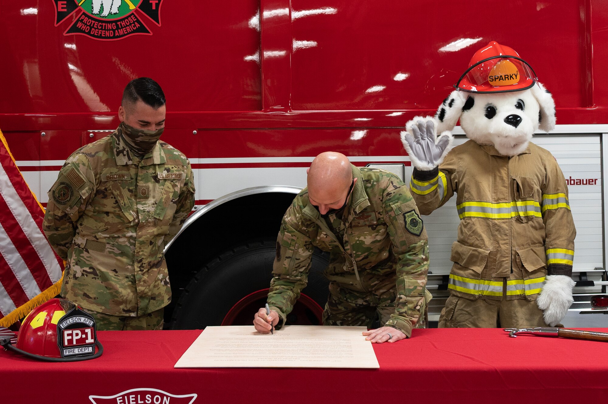 U.S. Air Force Col. David Berkland, the 354th Fighter Wing commander, signs the fire prevention week proclamation on Eielson Air Force Base, Alaska, Sept. 17, 2021.