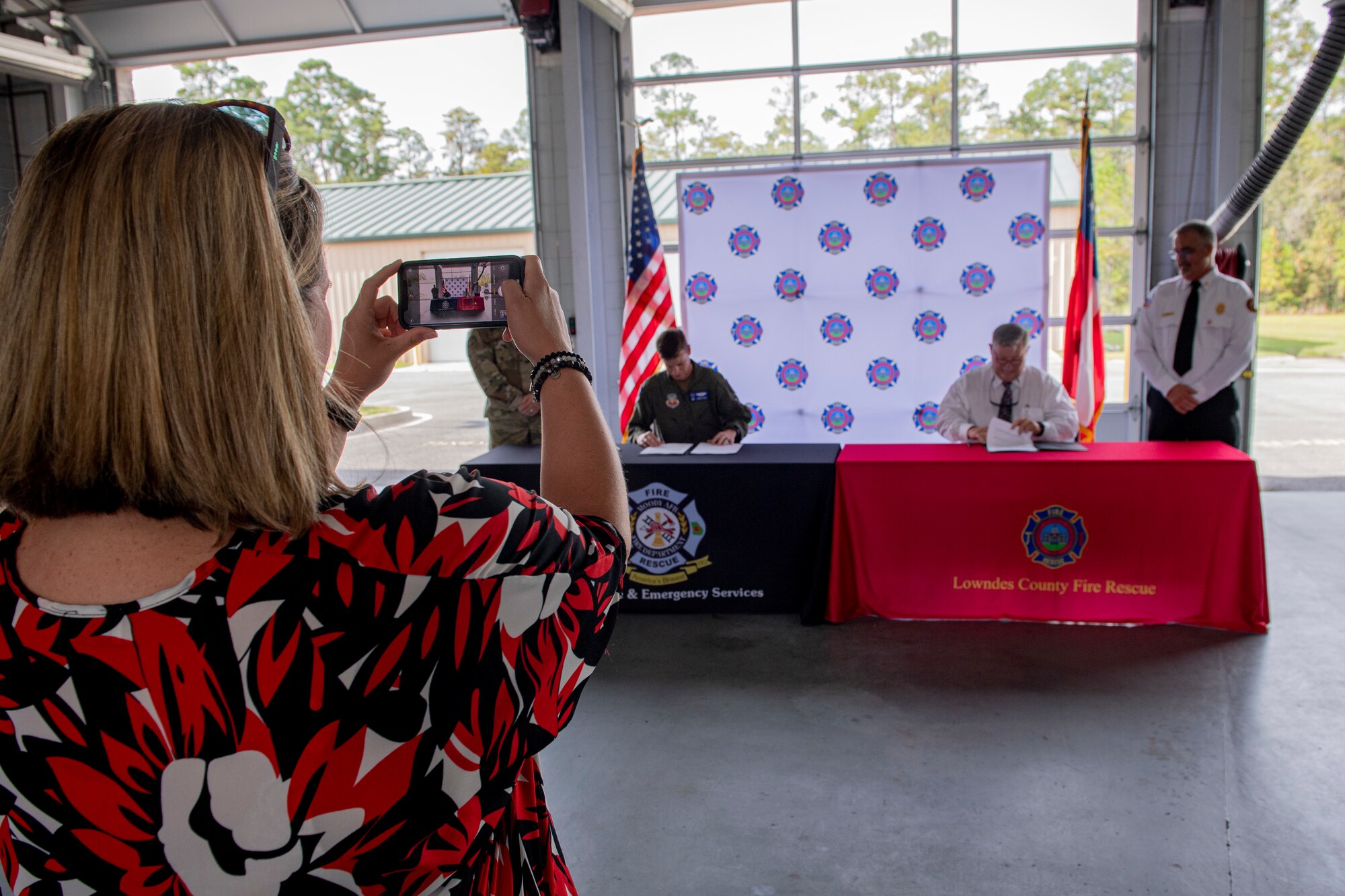 A photographer takes a photo of a signature panel