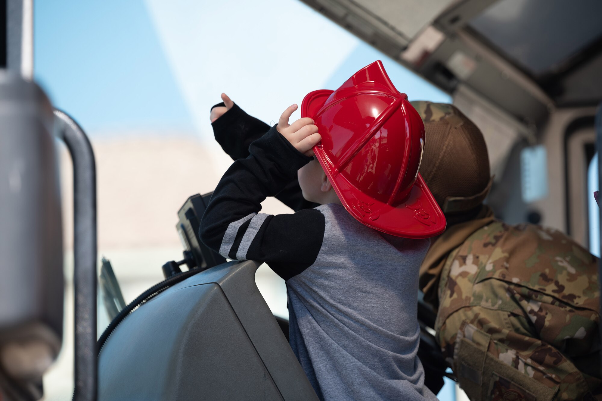 Kid and firefighter in truck