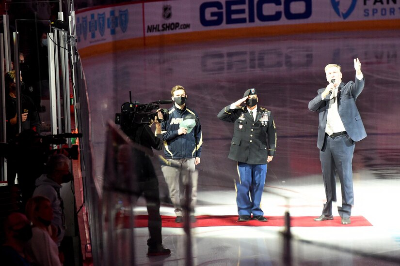 Chicago Blackhawks National Hockey League team honors Sgt. Maj. Dennis Koski, right, 85th U.S. Army Reserve Support Command and U.S. Navy Veteran Lt. j.g. Ash Davis, during a home game at the United Center in Chicago, October 1, 2021.