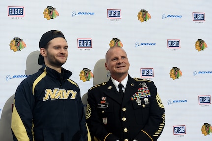 Chicago Blackhawks National Hockey League team honors Sgt. Maj. Dennis Koski, right, 85th U.S. Army Reserve Support Command, and U.S. Navy Veteran Lt. j.g. Ash Davis, during a home game, at the United Center in Chicago, October 1, 2021.