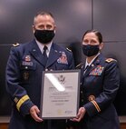 Maj. Gen. Eric Little, National Guard Bureau, Manpower and Personnel Directorate, presents Col. Melissa Beauman the Certificate of Retirement during Beauman’s retirement ceremony Oct. 1 at the Illinois Military Academy, Camp Lincoln, Springfield, Illinois.