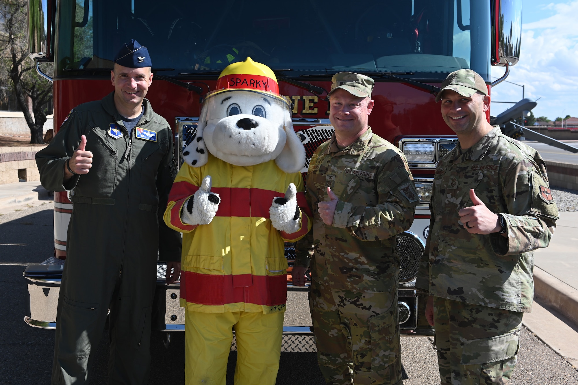 (From left to right) Col. Ryan Keeney, 49th Wing commander; Sparky the Fire Dog, National Fire Protection Association mascot; Senior Master Sgt. Cory Bowers, 49th Civil Engineer Squadron deputy fire chief and Chief Master Sgt. Thomas Temple, 49th Wing command chief, pose for a photo Oct. 1, 2021 on Holloman Air Force Base, New Mexico. Keeney signed the 2021 Fire Prevention Week proclamation on Oct. 1, formalizing the 49th Wing’s observance of national Fire Prevention Week. (U.S. Air Force photo by Staff Sgt. Christopher Sparks)