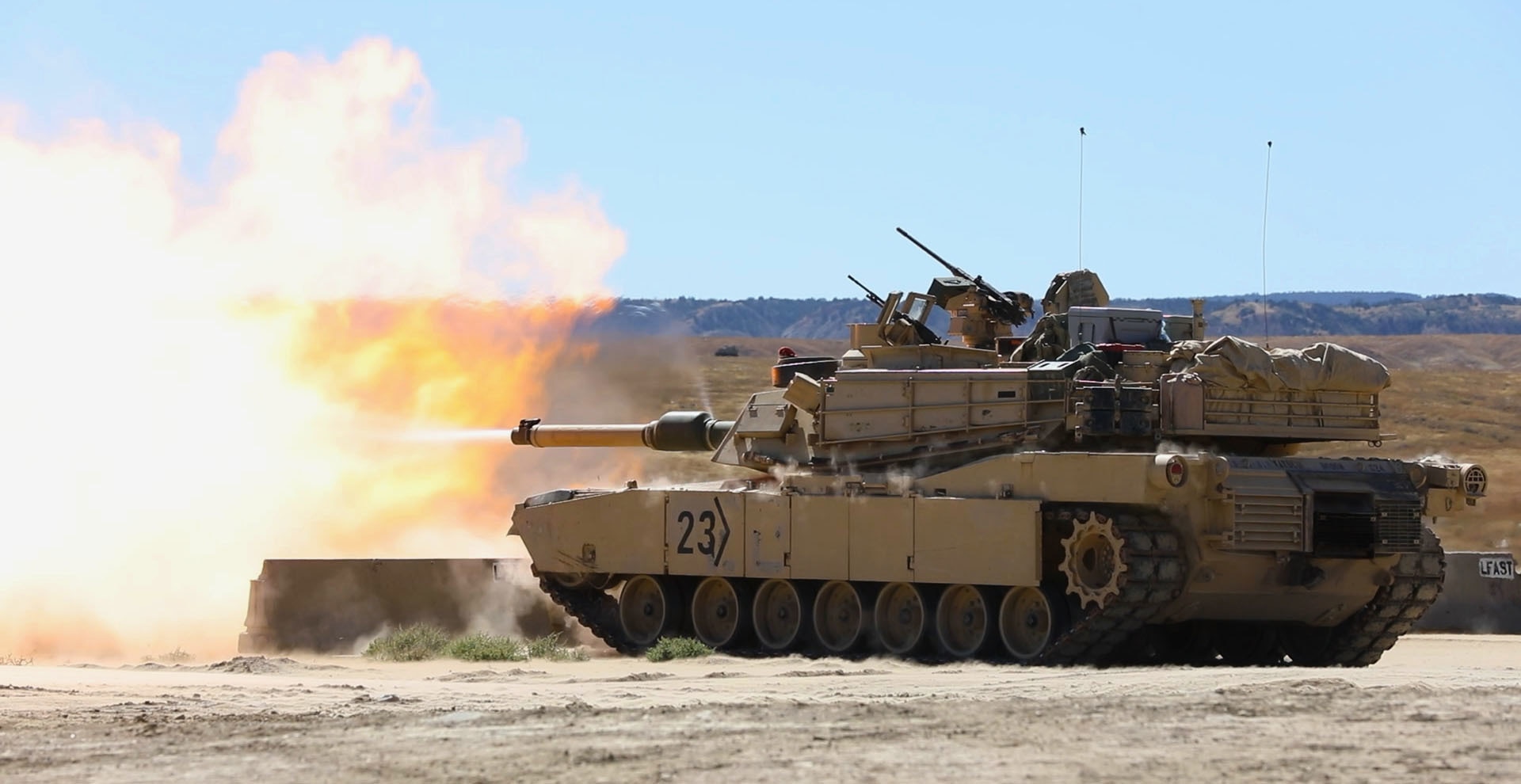A tank fires a round.
