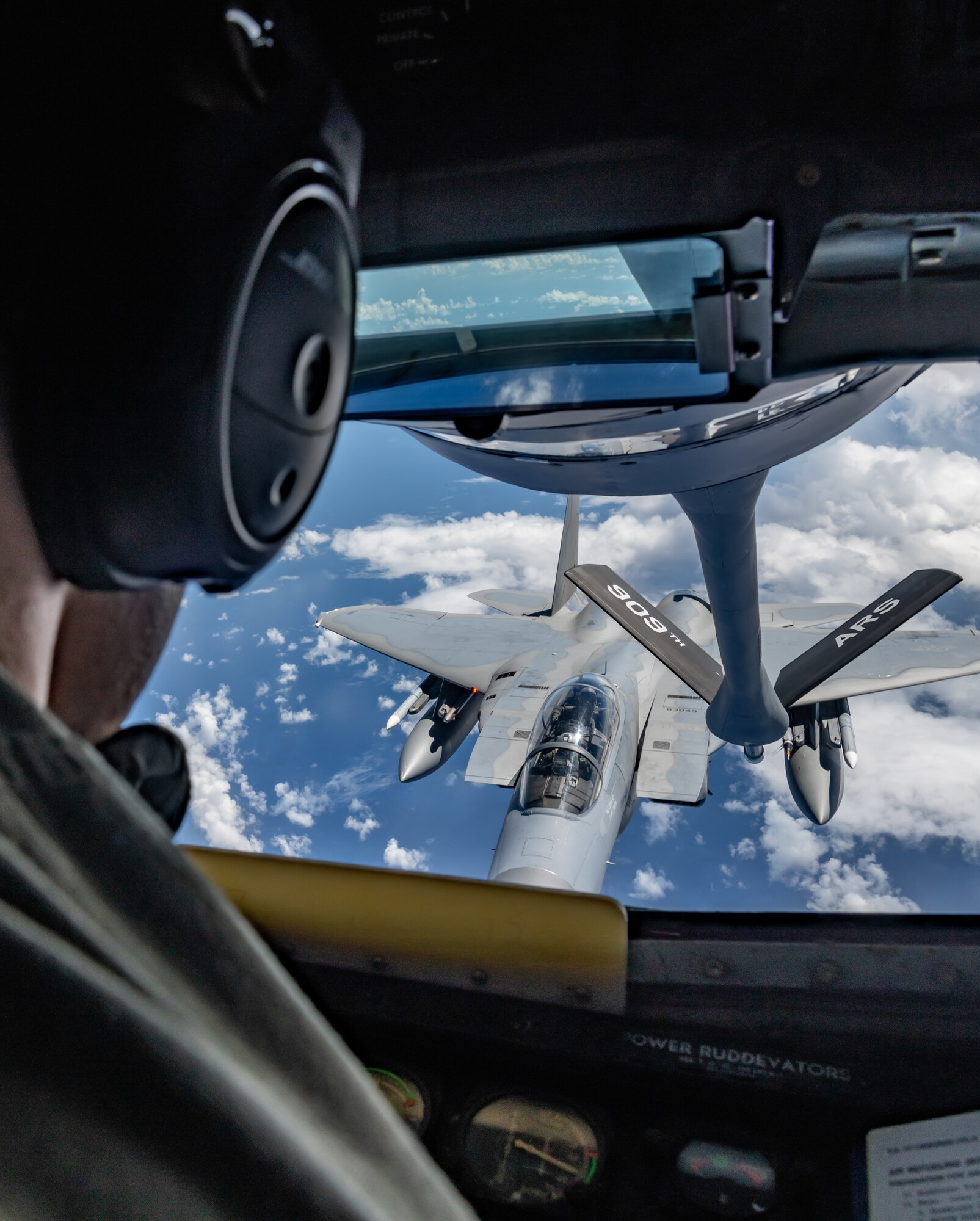 Boom operators from the 909th Air Refueling Squadron refuel F-15C Eagles.