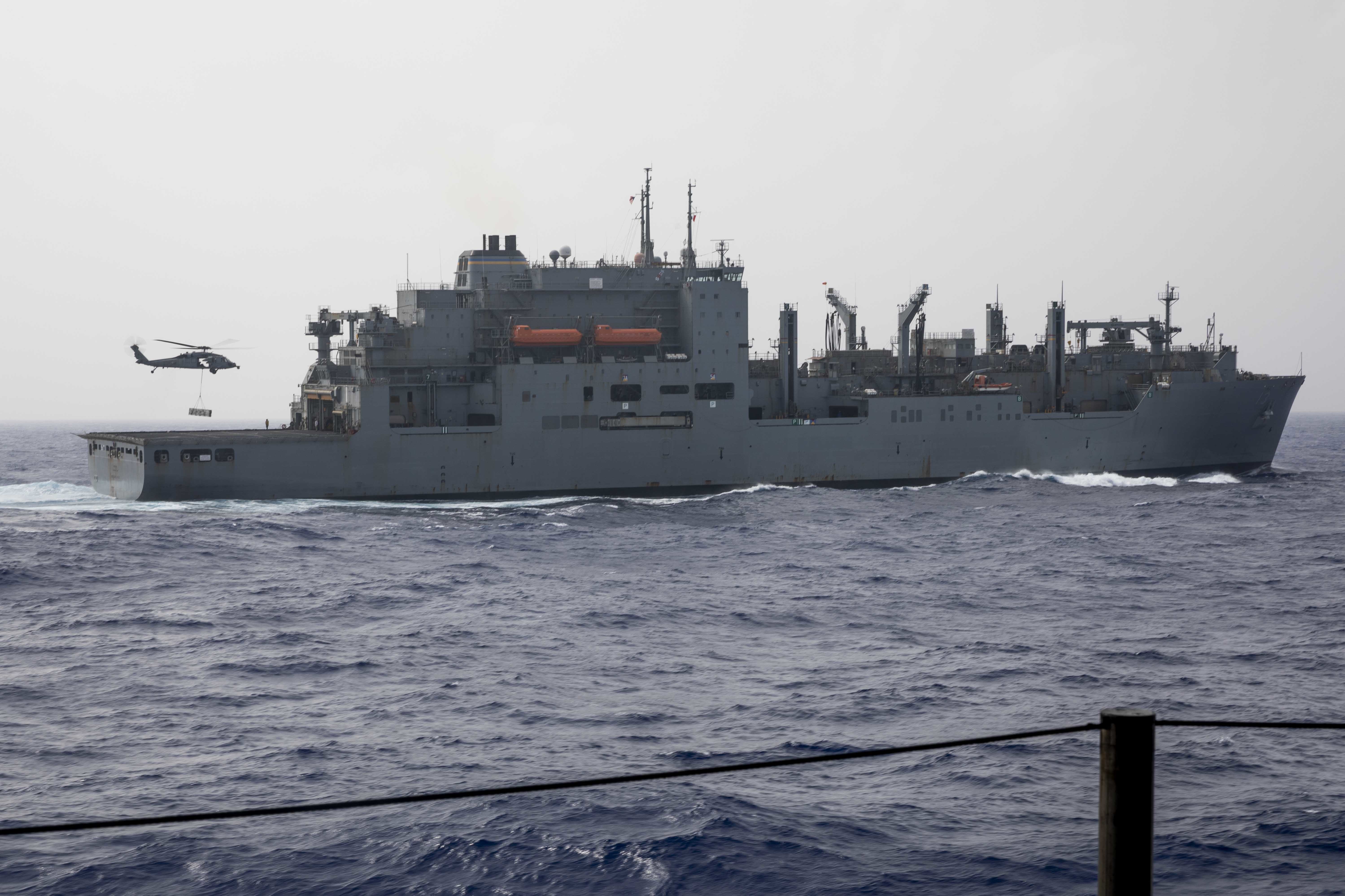 An MH-60S Sea Hawk helicopter transfers ammunition from USS Iwo Jima (LHD 7) to the Lewis and Clark-class dry cargo and ammunition ship USNS Medgar Evers (T-AKE 13), Oct. 2, 2021.