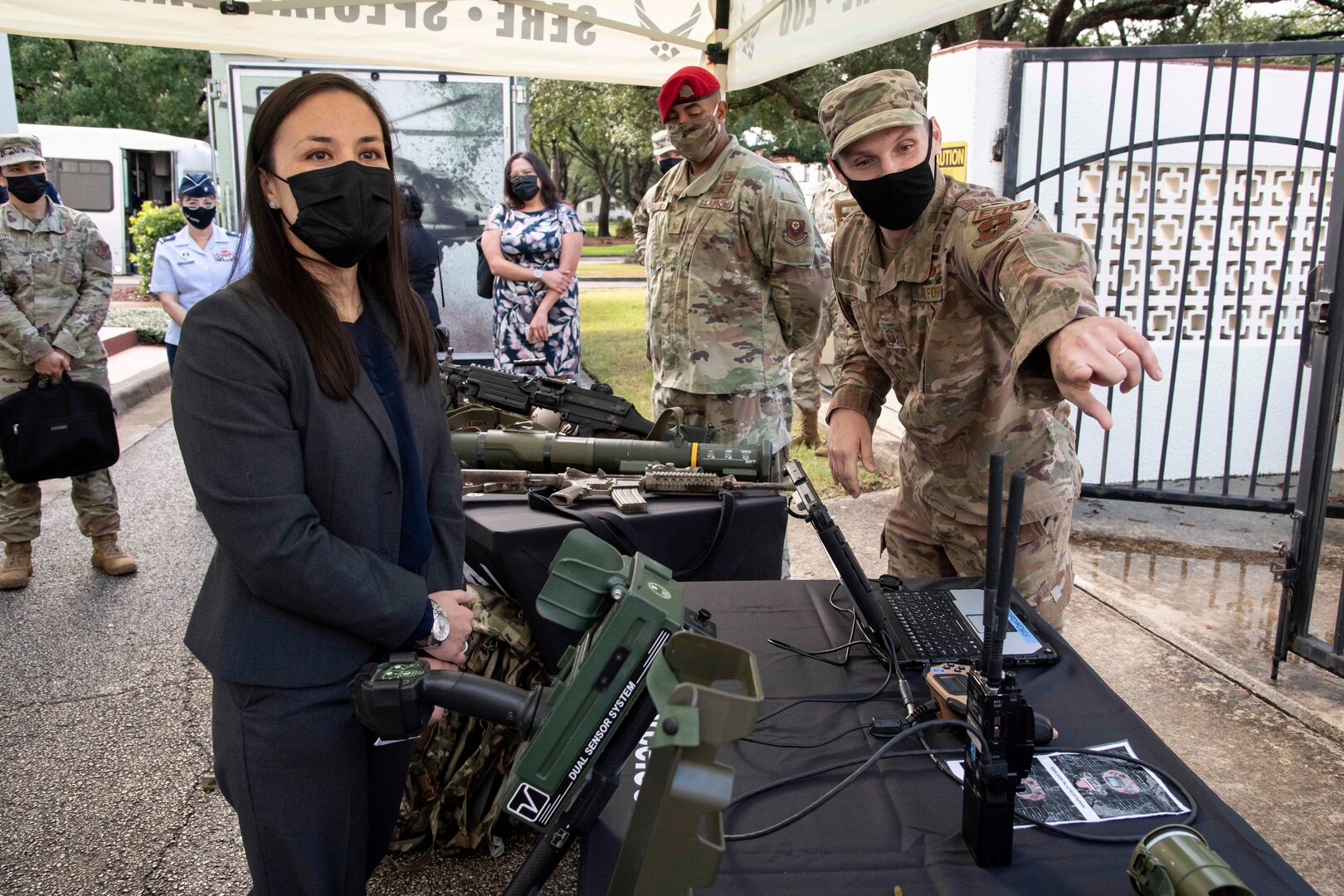 Undersecretary of the Air Force talking to an Airman explaining EOD equipment.