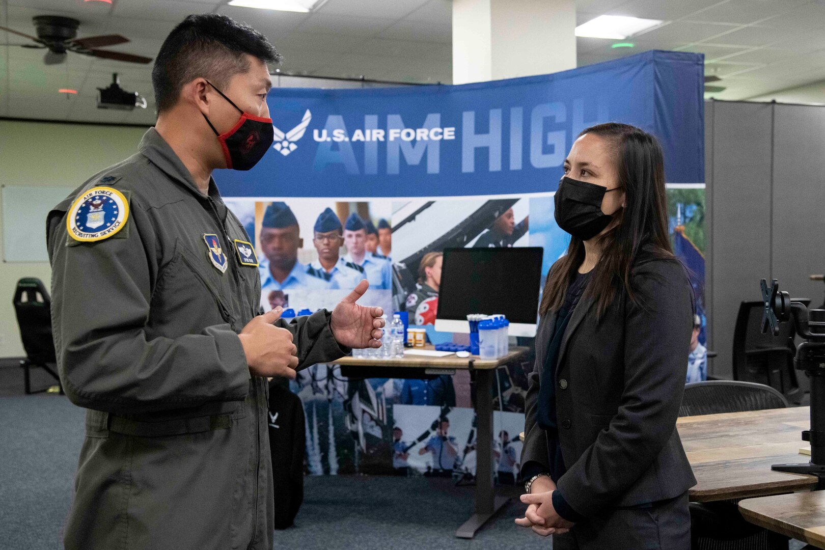 Undersecretary of the Air Force speaking to an Airman.