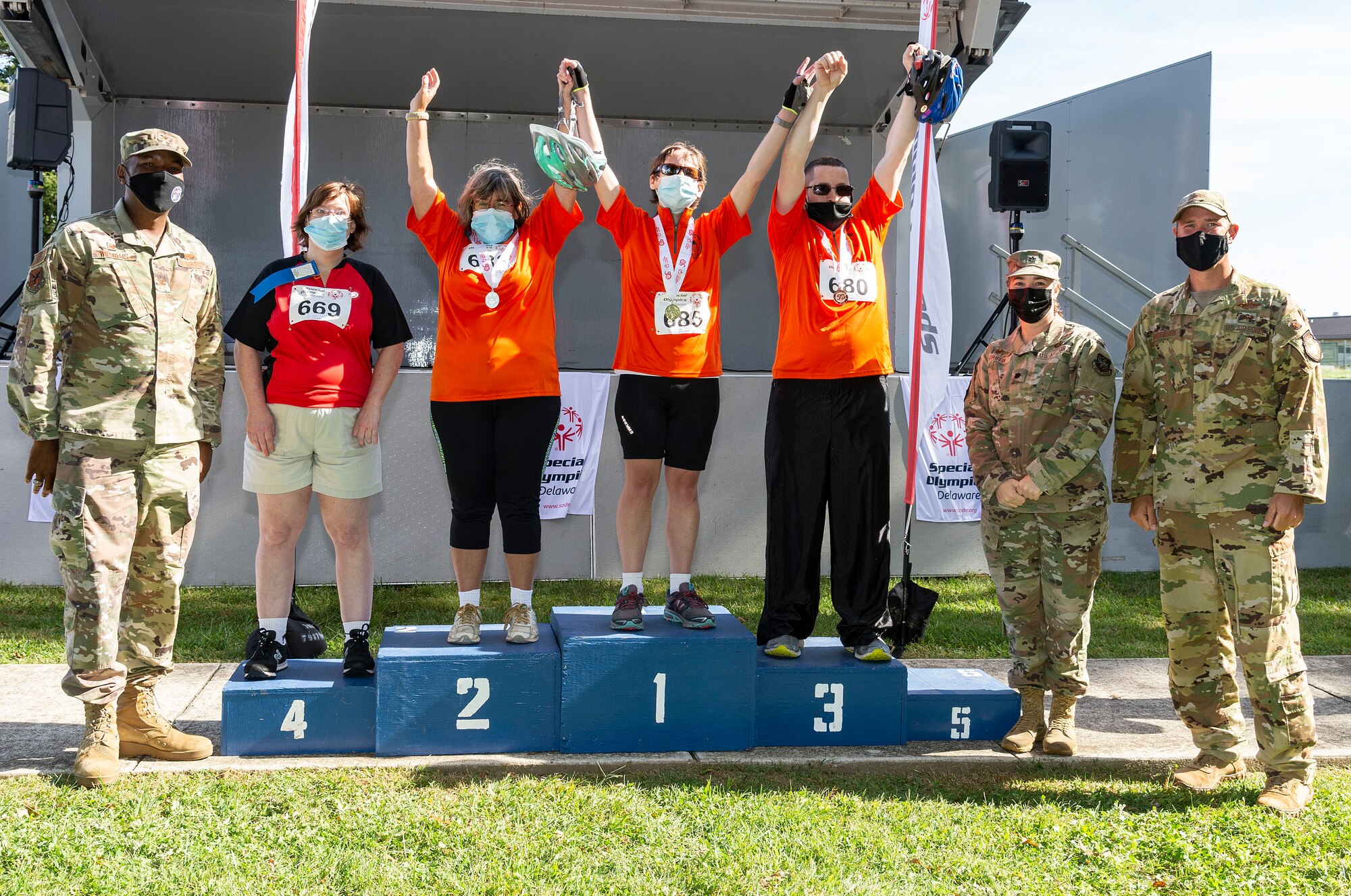 Col. Phelemon Williams, left, 436th Mission Support Group commander; Lt. Col. Kady Griffin, second from right, 436th Force Support Squadron commander and Col. Shanon Anderson, right, 436th Airlift Wing vice commander, stand with cyclists during the 2021 Special Olympics Delaware Cycling Classic at Dover Air Force Base, Delaware, Oct. 2, 2021.Team Dover senior leadership presented medals to the top three finishers in each event. (U.S. Air Force photo by Roland Balik)