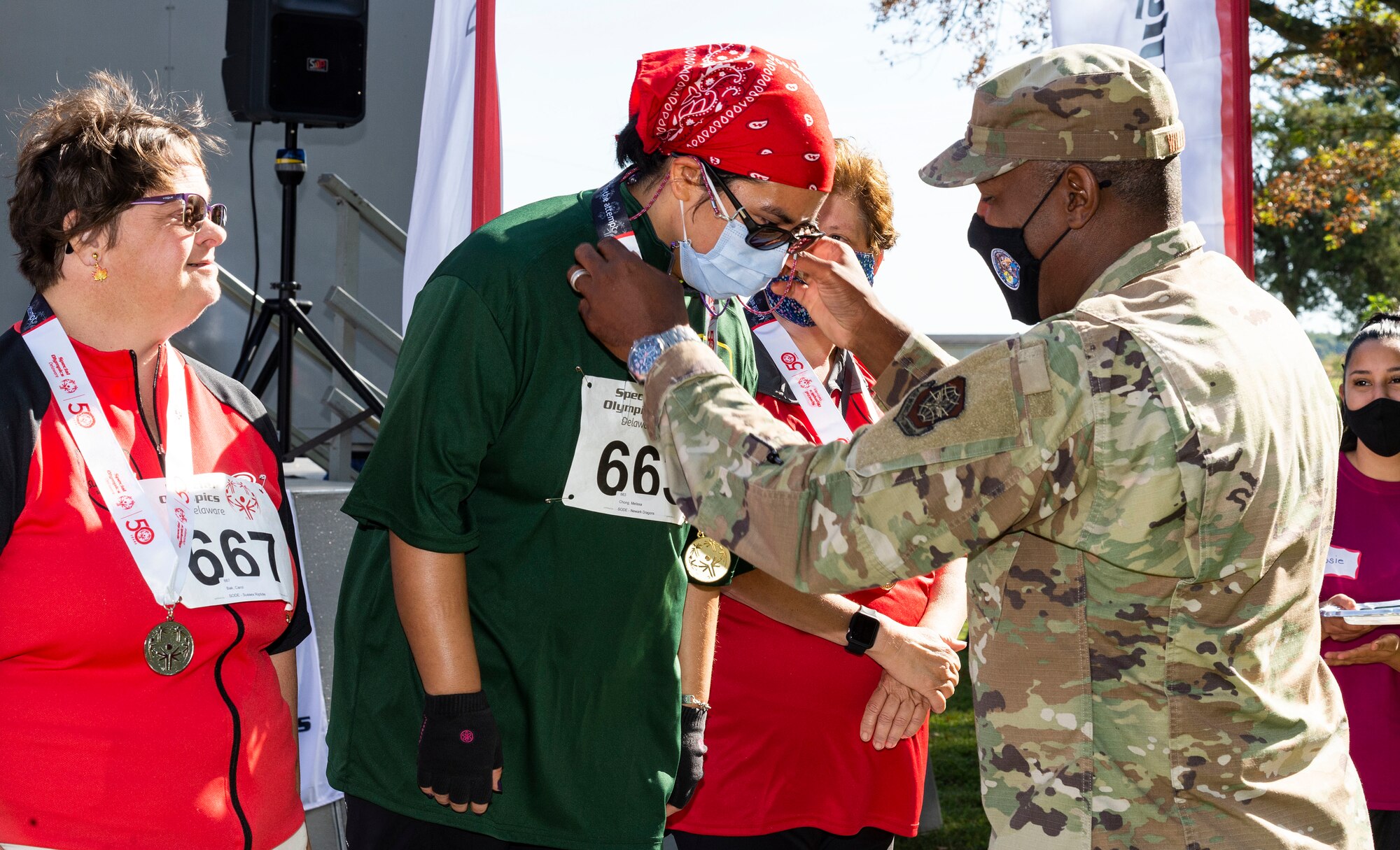 Col. Phelemon Williams, right, 436th Mission Support Group commander, presents a gold medal to Melissa Chong at the 2021 Special Olympics Delaware Cycling Classic at Dover Air Force Base, Delaware, Oct. 2, 2021. More than 40 cyclists from Delaware and Virginia competed in this year's cycling classic. (U.S. Air Force photo by Roland Balik)