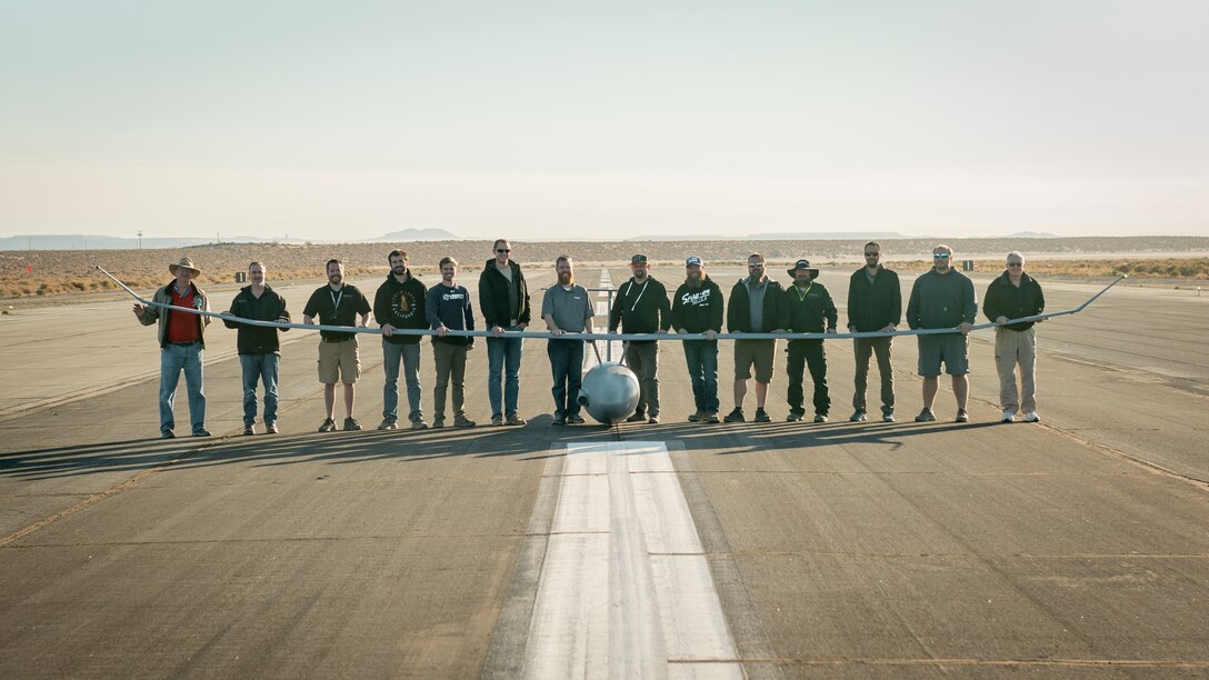 Platform Aerospace and Emerging Technologies-Combined Test Force personnel celebrate the Vanilla unmanned aircraft system's record-setting flight of 8 days, 50 minutes, and 47 seconds, and 12,200 miles of continuous flight, at Edwards Air Force Base, California, Oct 2. The aircraft broke the world record for unrefueled, internal combustion endurance of an unmanned aircraft and was launched from Rogers Dry Lakebed on Friday, Sept. 24. (Air Force photo by Bryce Bennett)