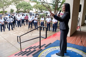 Undersecretary of the Air Force walking past BMT gear issued to trainees.