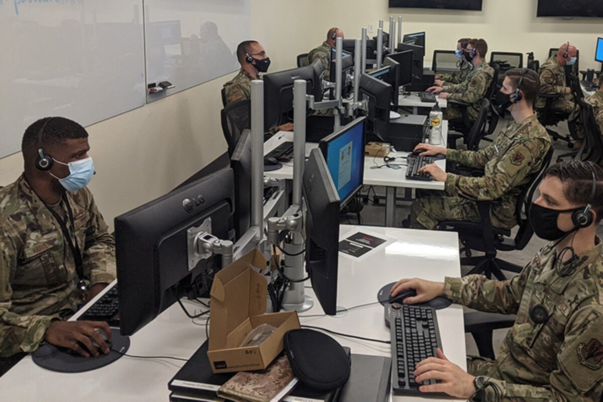 Airmen work on computers.
