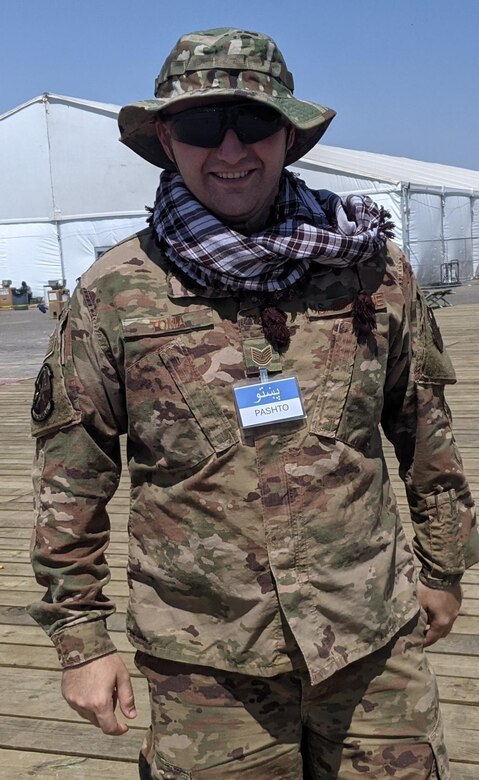 Tech. Sgt. Steven Toma, Task Force-Holloman interpreter deployed from Goodfellow Air Force Base, Texas, poses for a photo at Aman Omid Village on Holloman Air Force Base, New Mexico, Sept. 20, 2021. The Department of Defense, through U.S. Northern Command, and in support of the Department of State and Department of Homeland Security, is providing transportation, temporary housing, medical screening, and general support for at least 50,000 Afghan evacuees at suitable facilities, in permanent or temporary structures, as quickly as possible. This initiative provides Afghan evacuees essential support at secure locations outside Afghanistan. (U.S. Air Force photo by Staff Sgt. Kenneth Boyton)