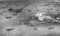 Aerial photo of Guantanamo Bay Naval Station in early 1940s, showing the fleet at anchor and seaplane ramp in the foreground. (U.S. Navy photo)