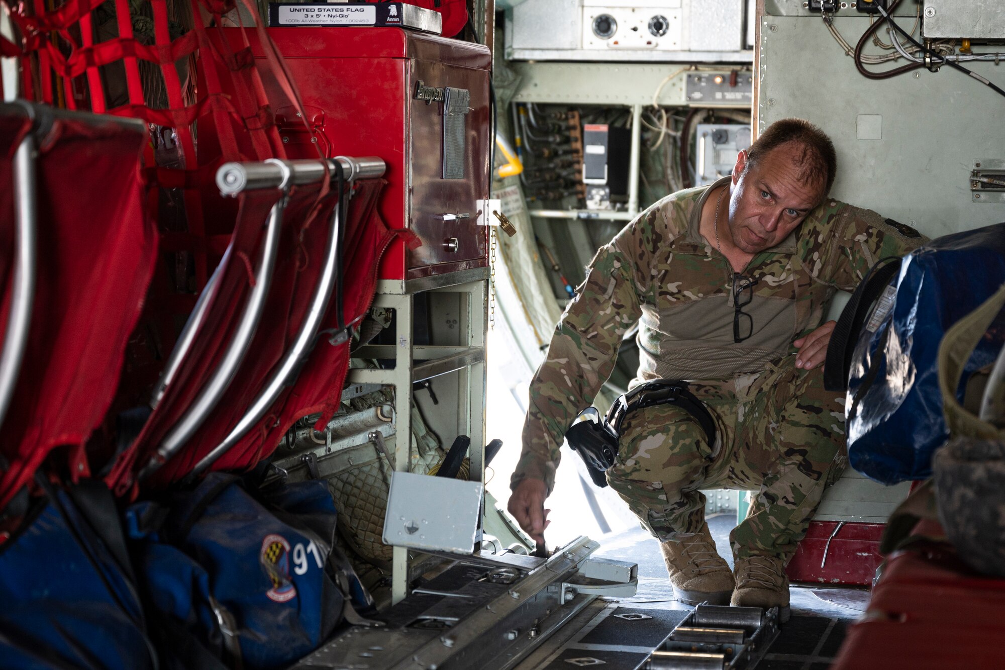 Senior Master Sgt. Mickey Dixon, a loadmaster with the 779th Expeditionary Airlift Squadron, prepares a C-130H Hercules for cargo at Ali Al Salem Air Base, Kuwait, Sept. 16, 2021.