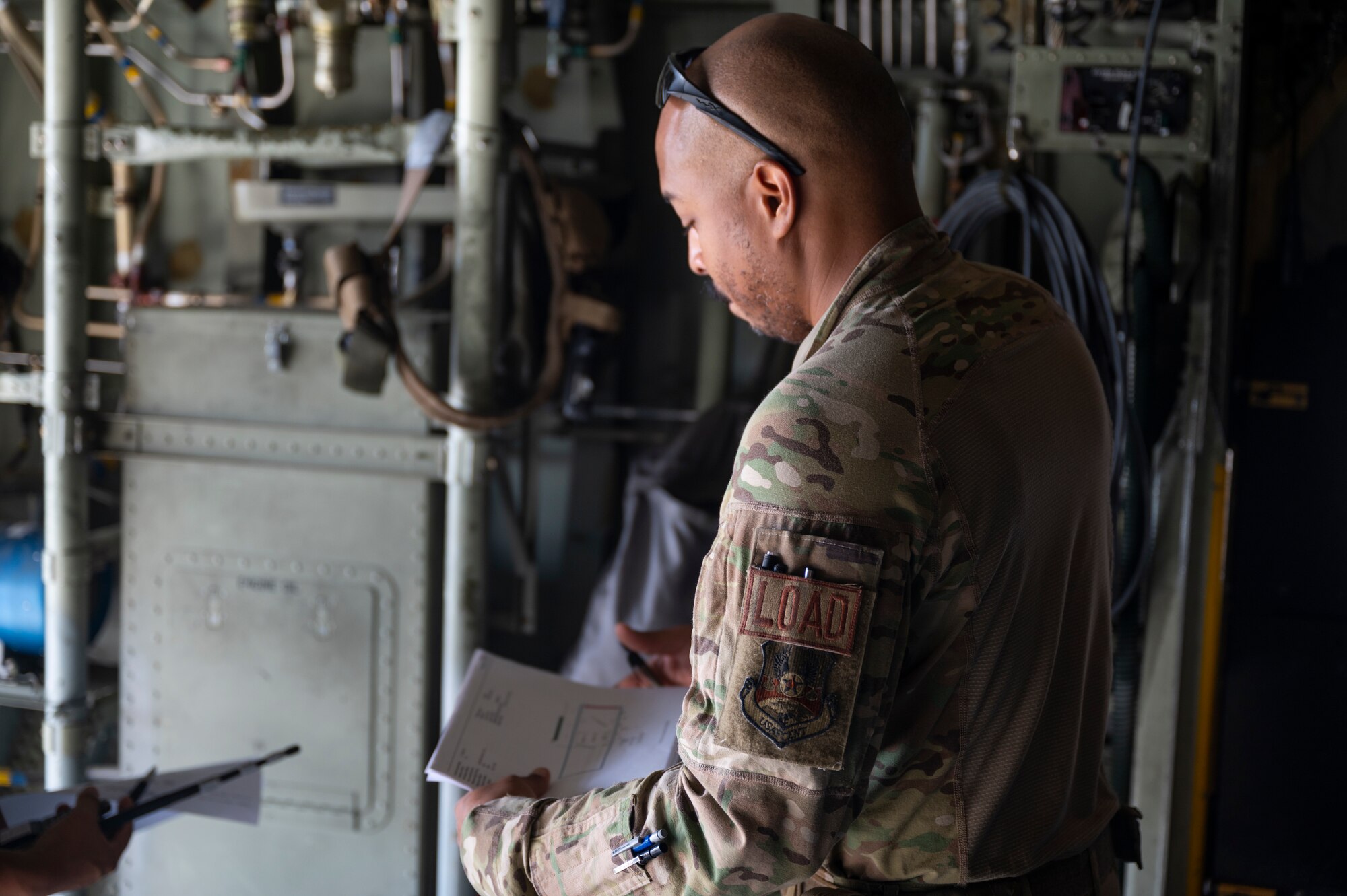 Tech. Sgt. Michael Jefferson, a loadmaster with the 779th Expeditionary Airlift Squadron, reviews cargo logs on a C-130H Hercules at Ali Al Salem Air Base, Kuwait, Sept. 16, 2021.