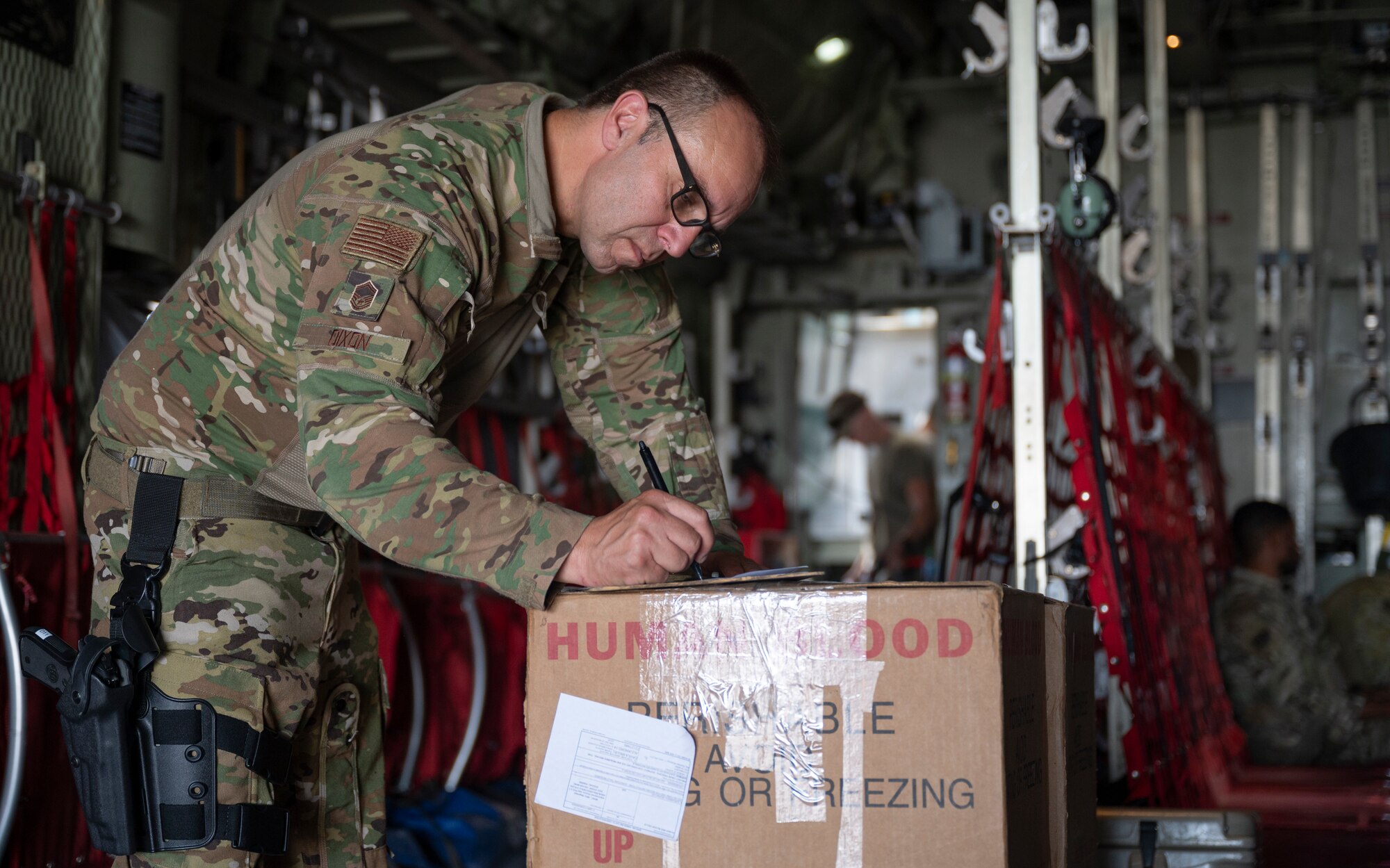 Senior Master Sgt. Mickey Dixon, a loadmaster with the 779th Expeditionary Airlift Squadron, reviews cargo documents on a C-130H Hercules at Ali Al Salem Air Base, Kuwait, Sept. 16, 2021.